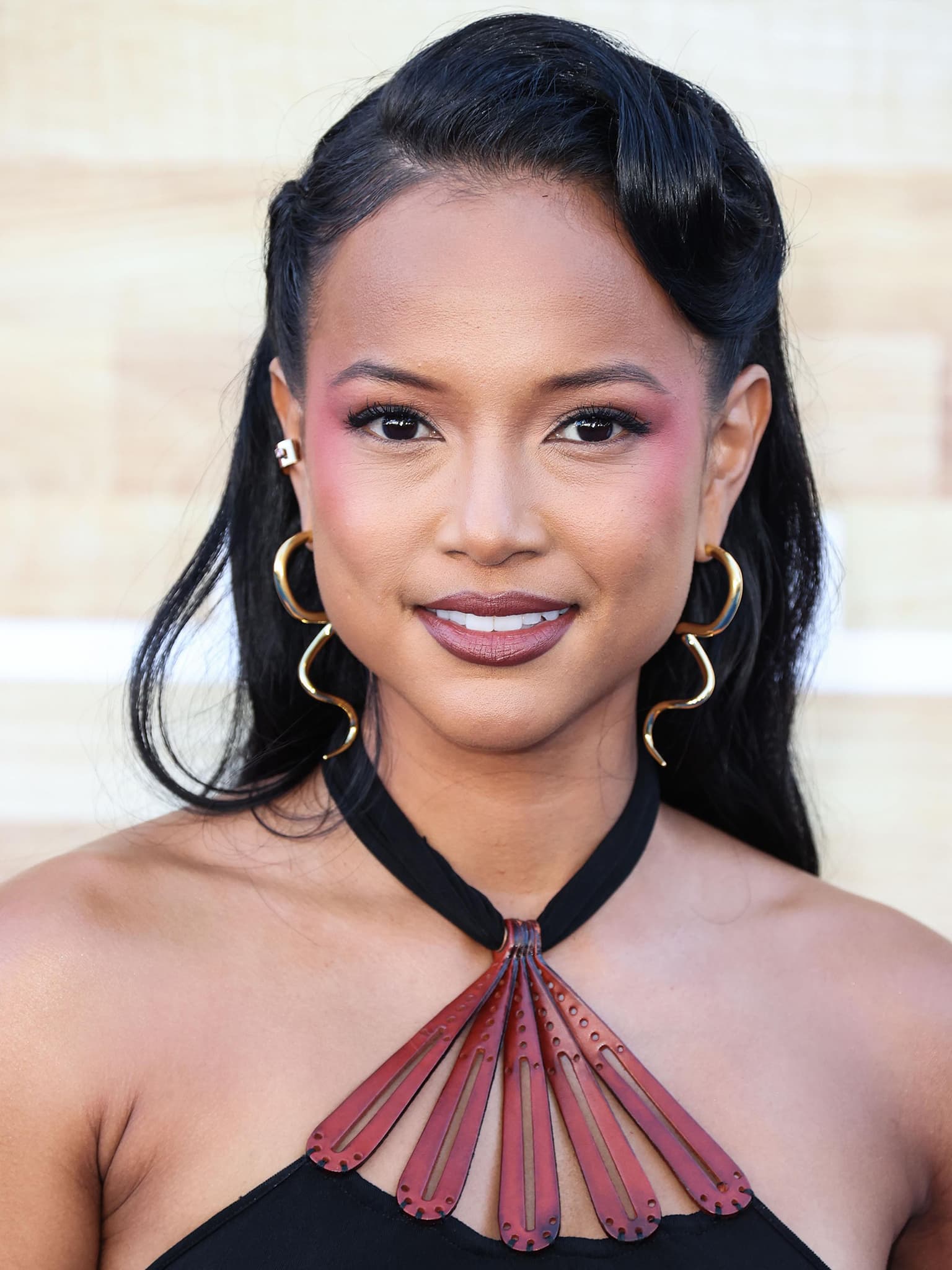 Karrueche Tran styles her tresses in retro waves and wears purple eyeshadow that goes down her cheeks