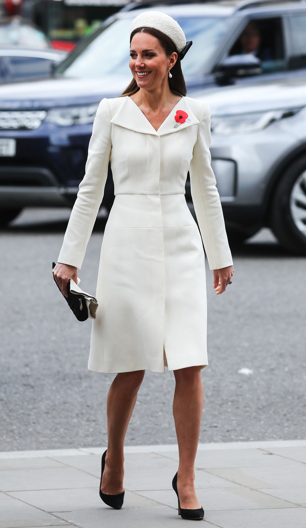 Duchess of Cambridge in Alexander McQueen custom white coat, Jane Taylor Calypso Halo, and Gianvito Rossi pumps for Anzac Day Service on April 25, 2022