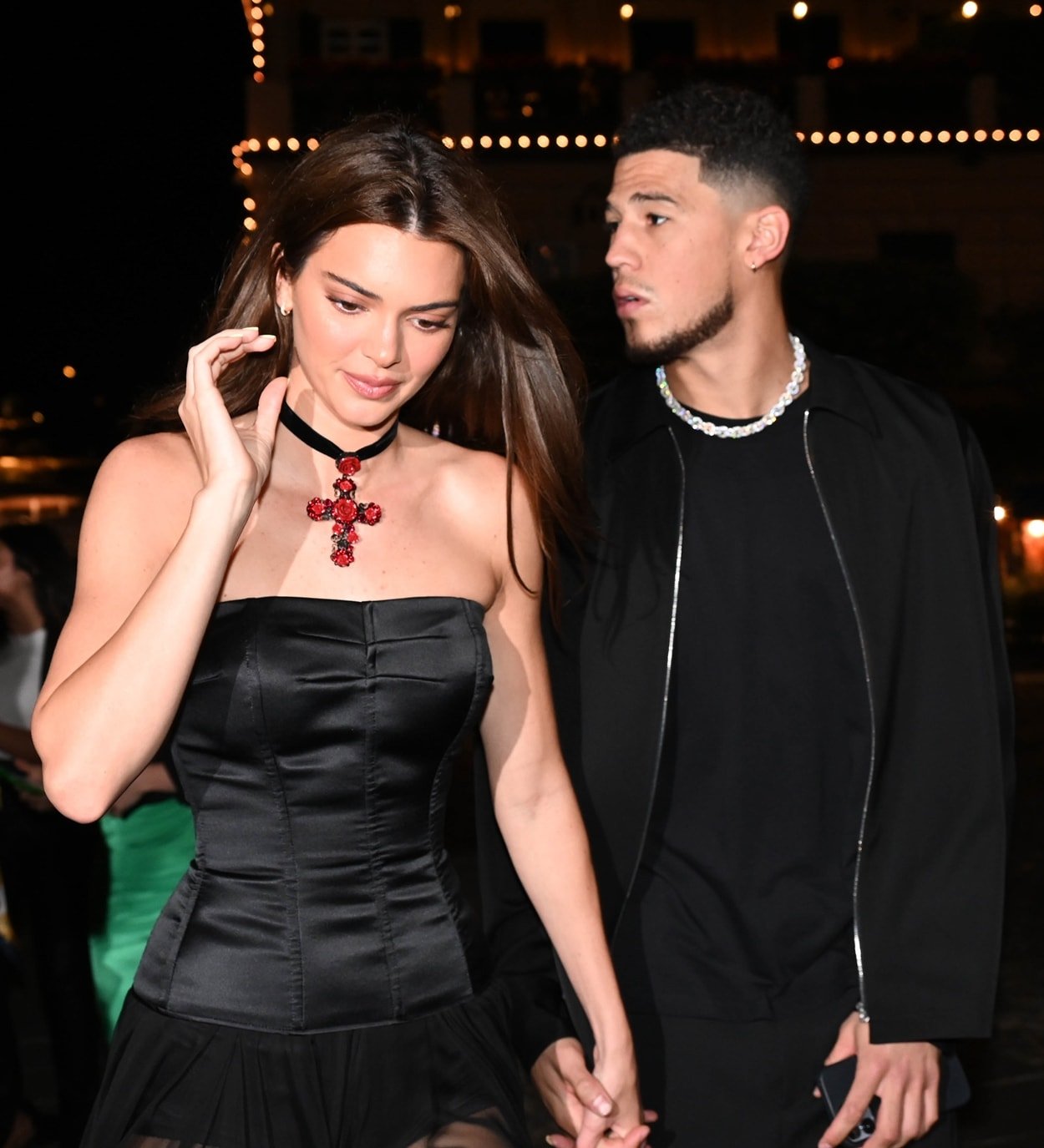 Kendall Jenner in a Dolce & Gabbana Spring 1995 dress styled with a Dolce & Gabbana rose crucifix steps out for dinner with her boyfriend Devin Booker