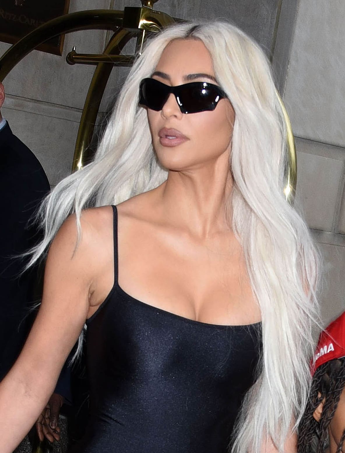 Kim Kardashian wears her long platinum hair in waves and glams up with her signature matte nude lipstick