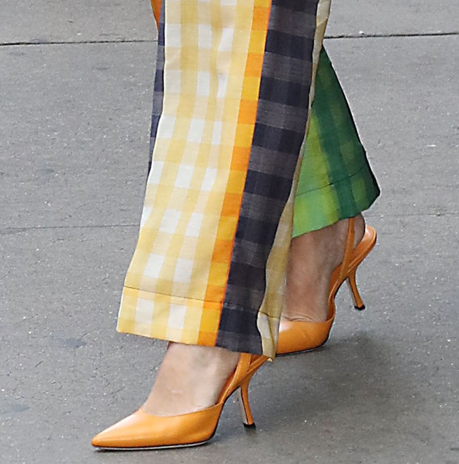 Kristen Bell pairs her colorful outfit with By Far x Mimi Cuttrell orange slingback pumps