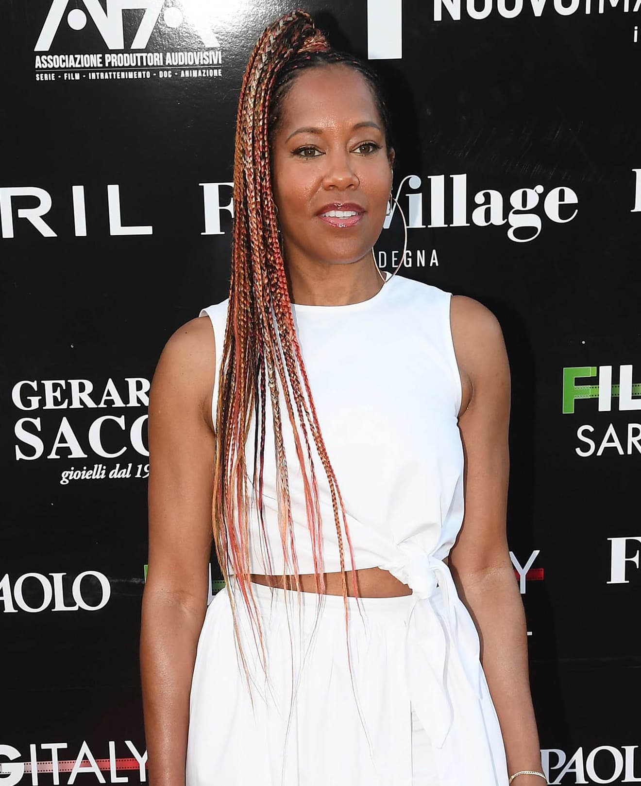 Regina King wears her long braided hair in a high ponytail