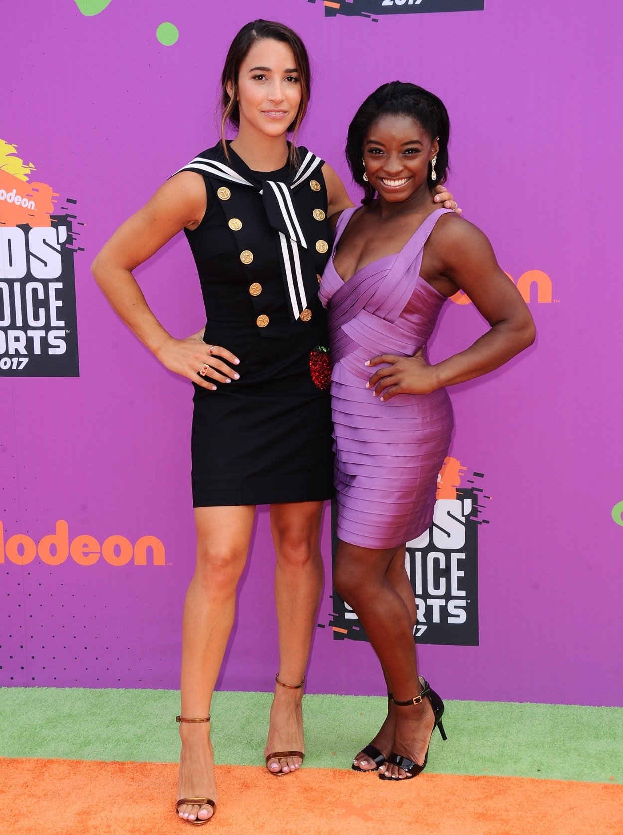 Simone Biles and much taller gymnast Aly Raisman flaunt their legs