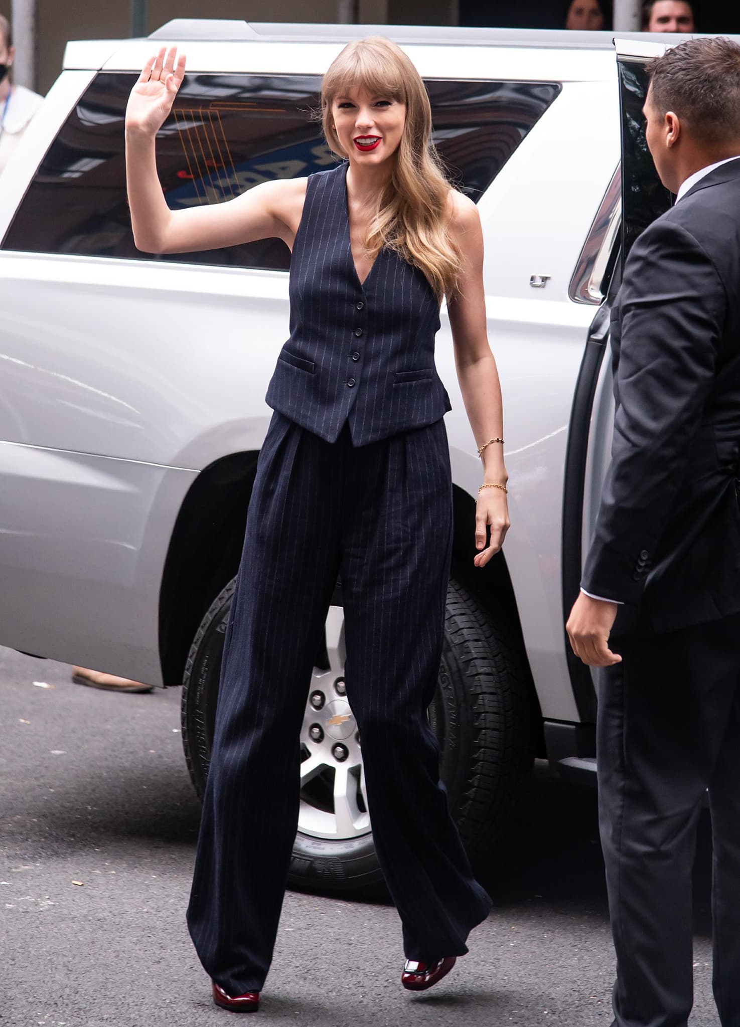 Taylor Swift opts for a boss lady look in Max Mara navy pinstripe vest and matching trousers