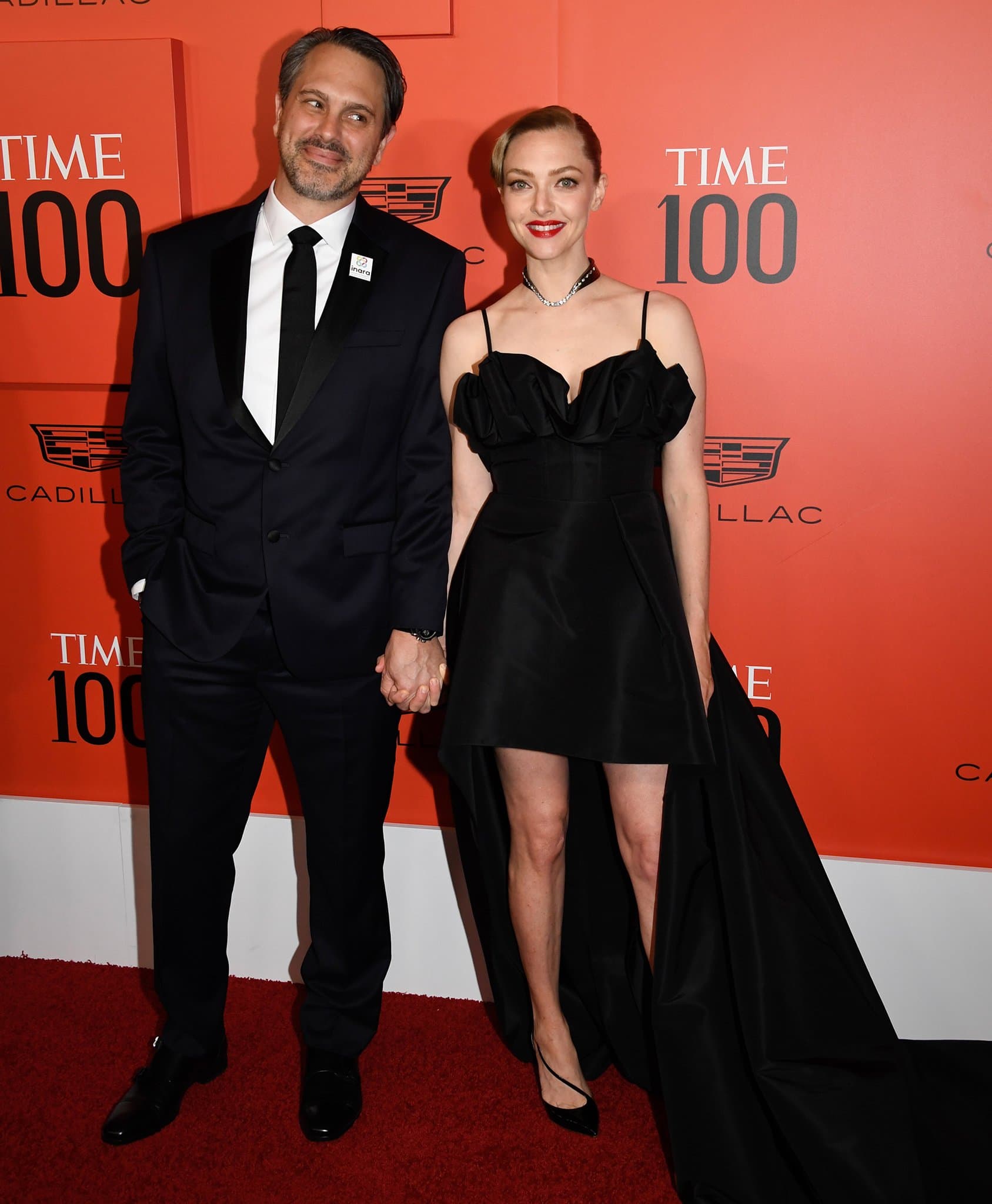 Thomas Sadoski joins her wife Amanda Seyfried in a black suit styled with black dress shoes and an INARA pin