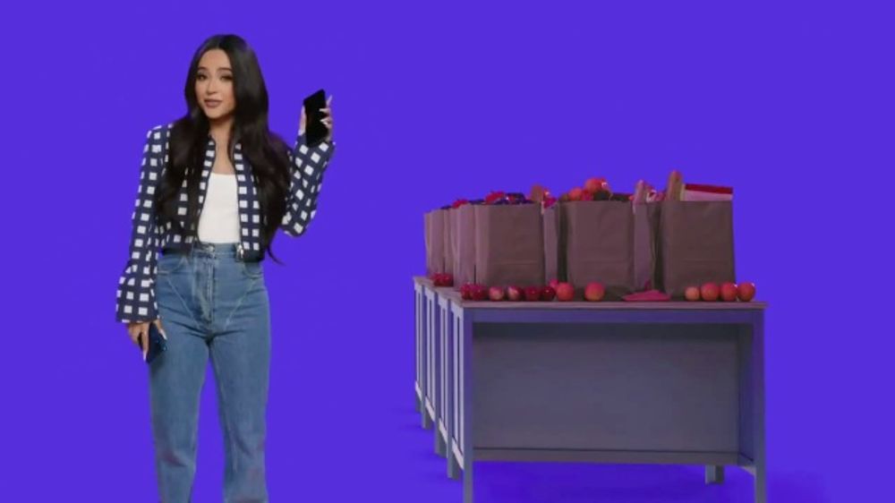 Becky G wearing a cropped jacket and weird ill-fitting jeans for Xfinity Mobile TV spot