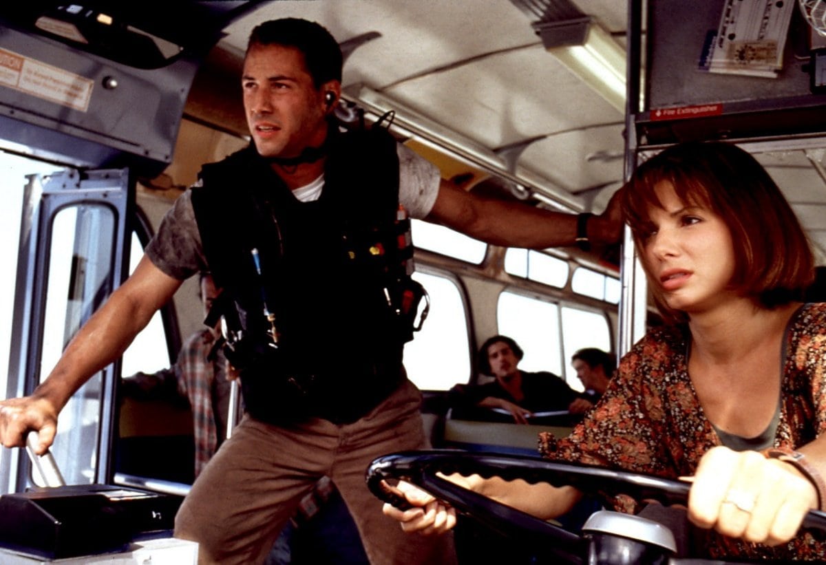 Keanu Reeves as Jack Traven and Sandra Bullock as Annie Porter showing off their chemistry in the 1994 action movie Speed