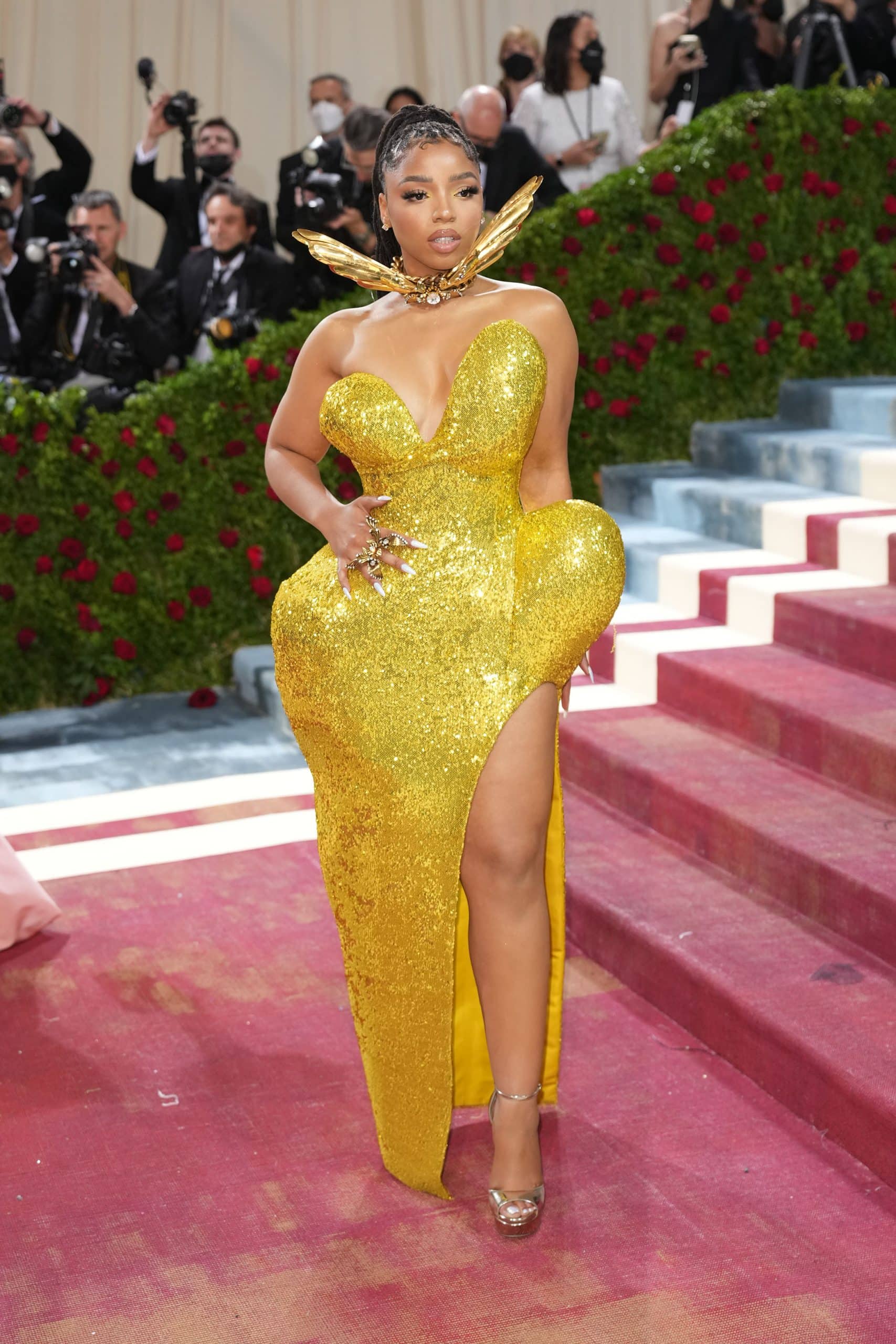 Chloe Bailey in a gold plunging Area gown with Jimmy Choo shoes at the 2022 Costume Institute Benefit celebrating In America: An Anthology of Fashion at the Metropolitan Museum of Art