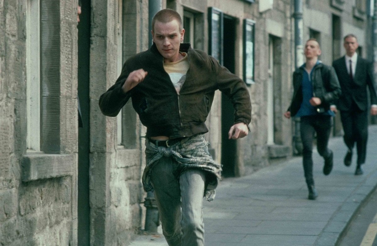 Ewan McGregor wears a black bomber jacket as Mark "Rent Boy" Renton in the 1996 Scottish black comedy-drama film Trainspotting