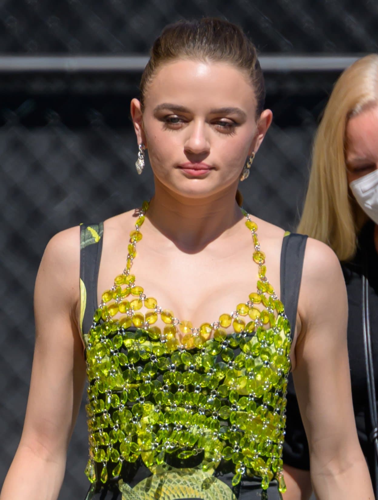 Joey King styles her tresses in a retro ponytail and wears subtle smokey eyeshadow and pink lipstick