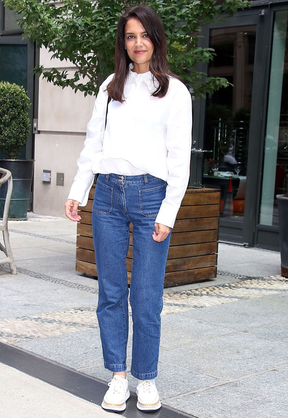 Katie Holmes wears blue jeans with a classic Chloé shirt that features romantic detail in the broderie anglaise collar