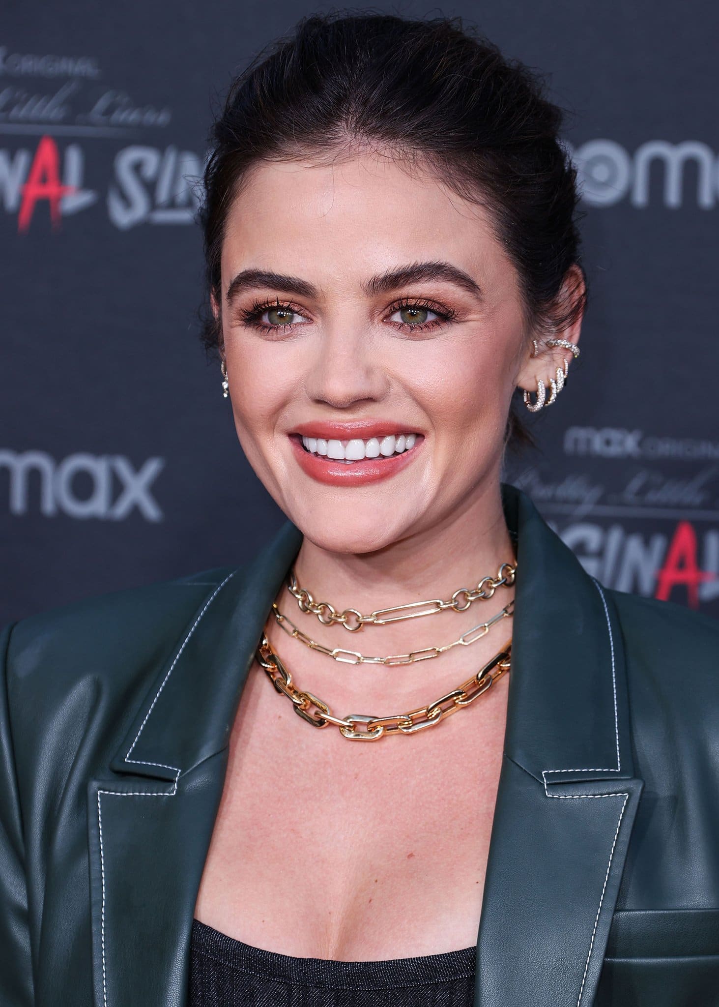 Lucy Hale sweeps her tresses into a messy updo and glams up with rose gold eyeshadow, mascara, and pink lipstick