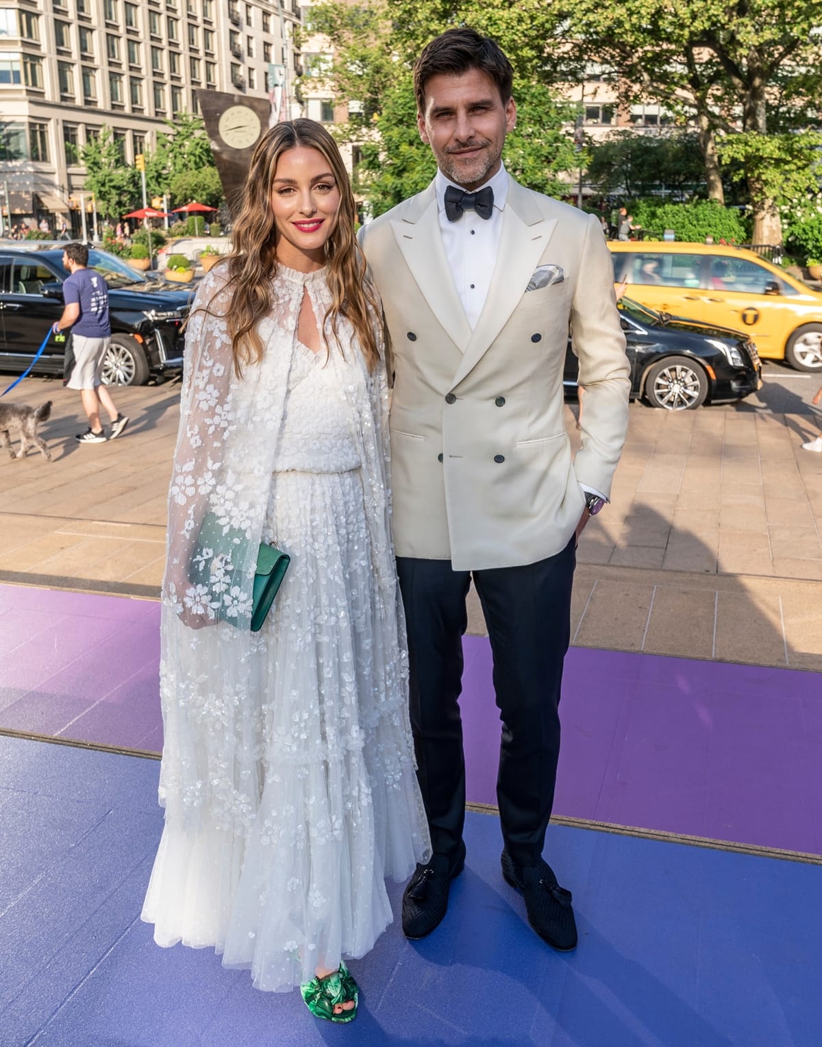Olivia Palermo in a white Needle & Thread 'Margot' dress and green Giambattista Valli malachite-print knot-detail mules, poses with her husband Johannes Huebl at the American Ballet Theatre Gala