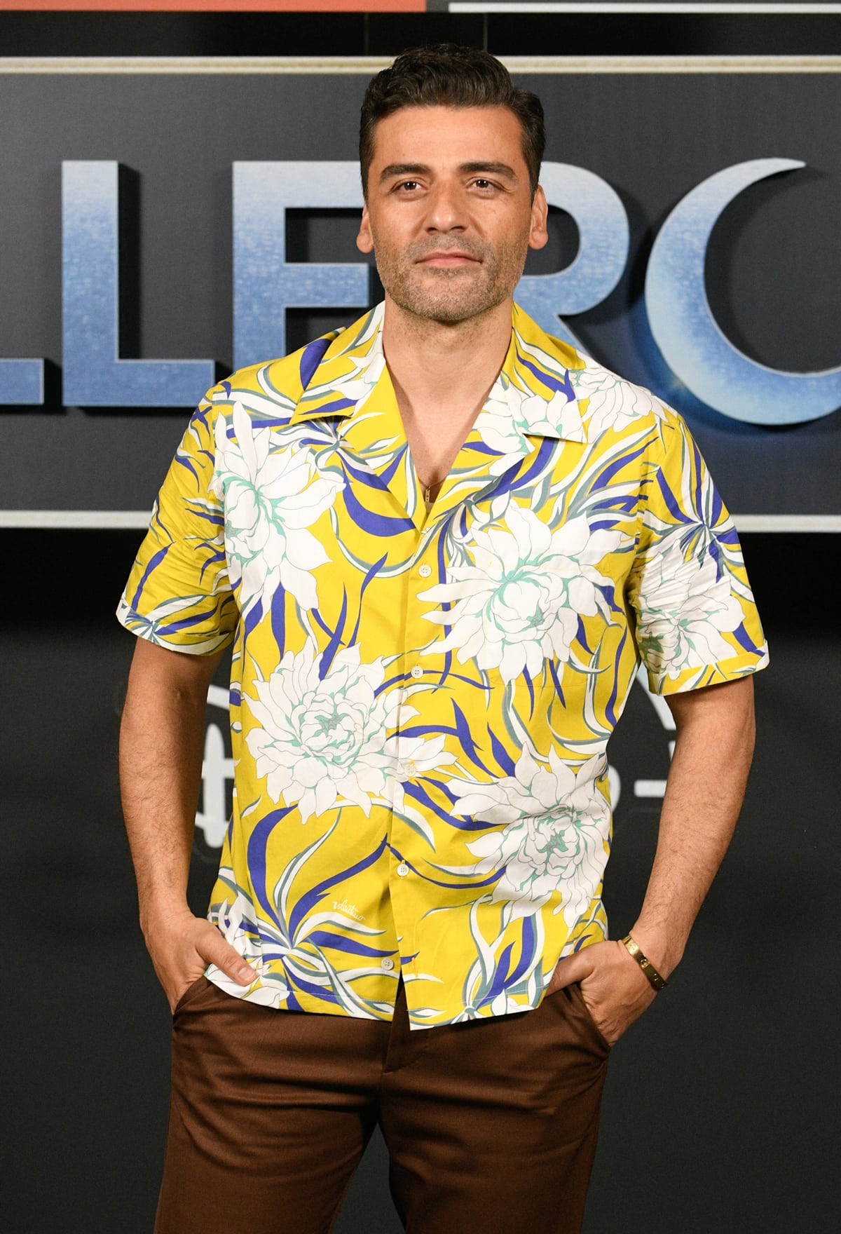 Oscar Isaac promotes Moon Knight in a Valentino bowling shirt in cotton poplin with all-over Street Flowers Couture Peonies print and brown pants