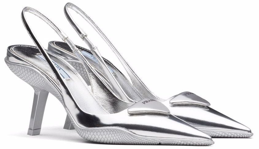 Prada's slingback pumps feature a rubber shell sole that envelops the metallic upper, blending feminine pointy shape and sporty references