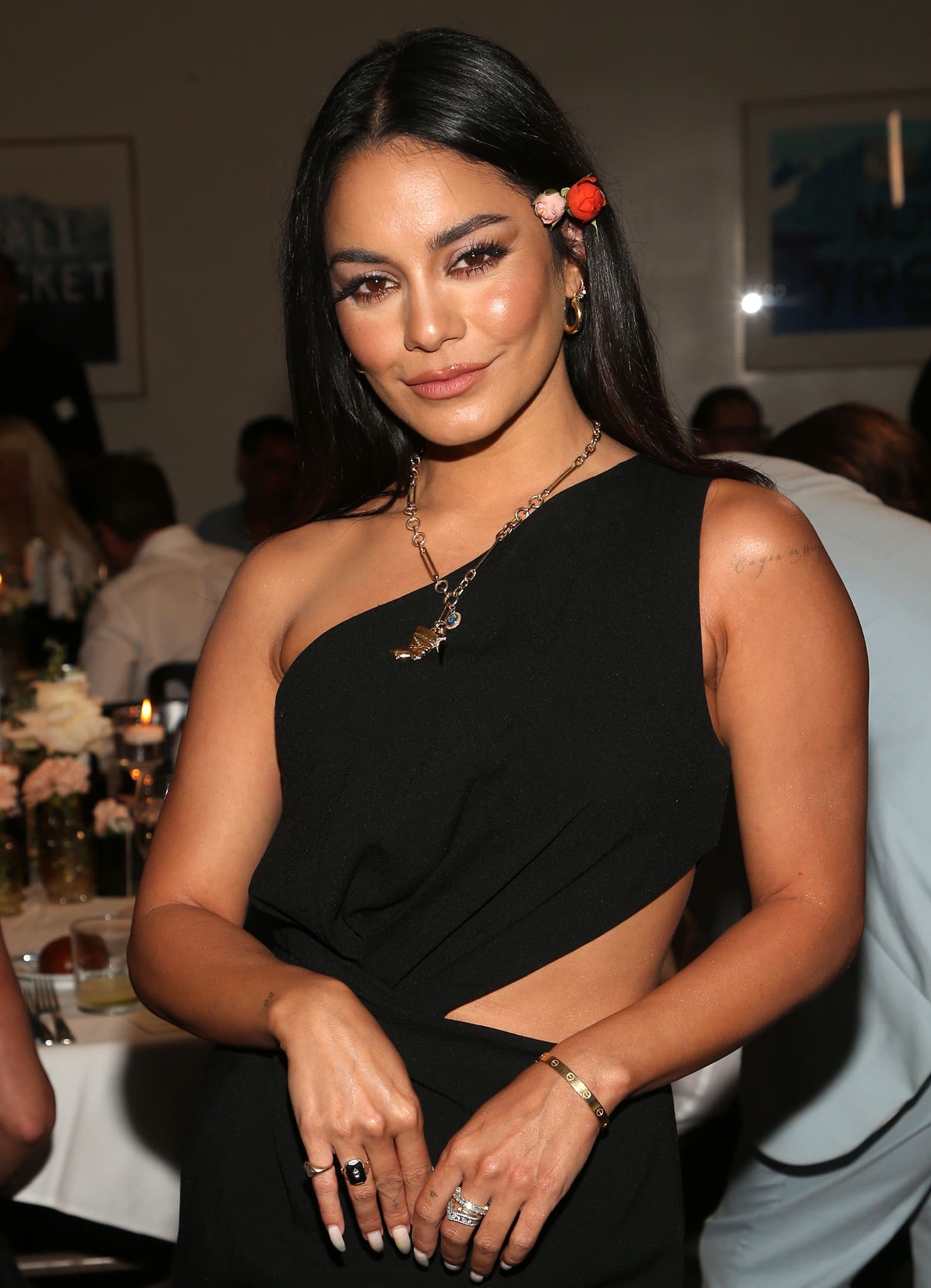 Vanessa Hudgens styles her look with statement rings, a Cartier bracelet, hoop earrings, and a Foundrae necklace with a Nefertiti pendant