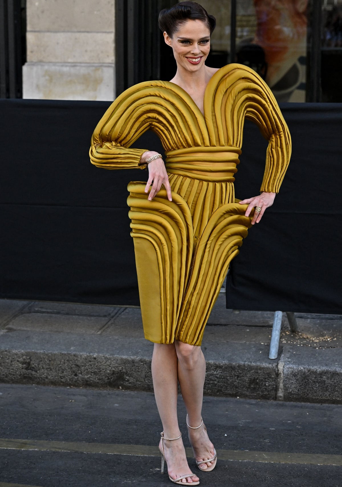 Coco Rocha in an archival Jean Paul Gaultier piece with a stylish updo and ankle-strap heels