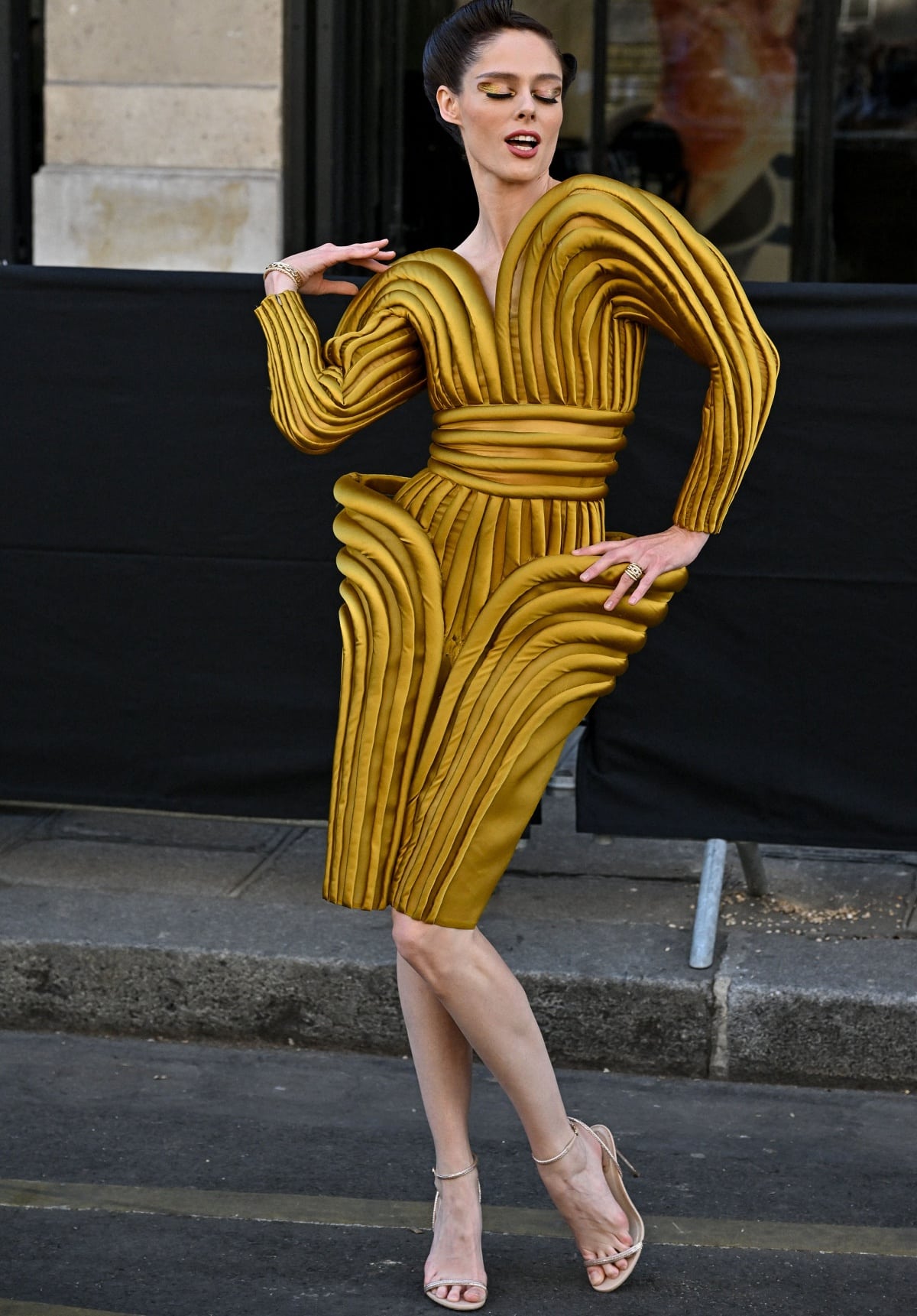 Coco Rocha posing in a gold archival piece for the Jean Paul Gaultier x Olivier Rousteing show