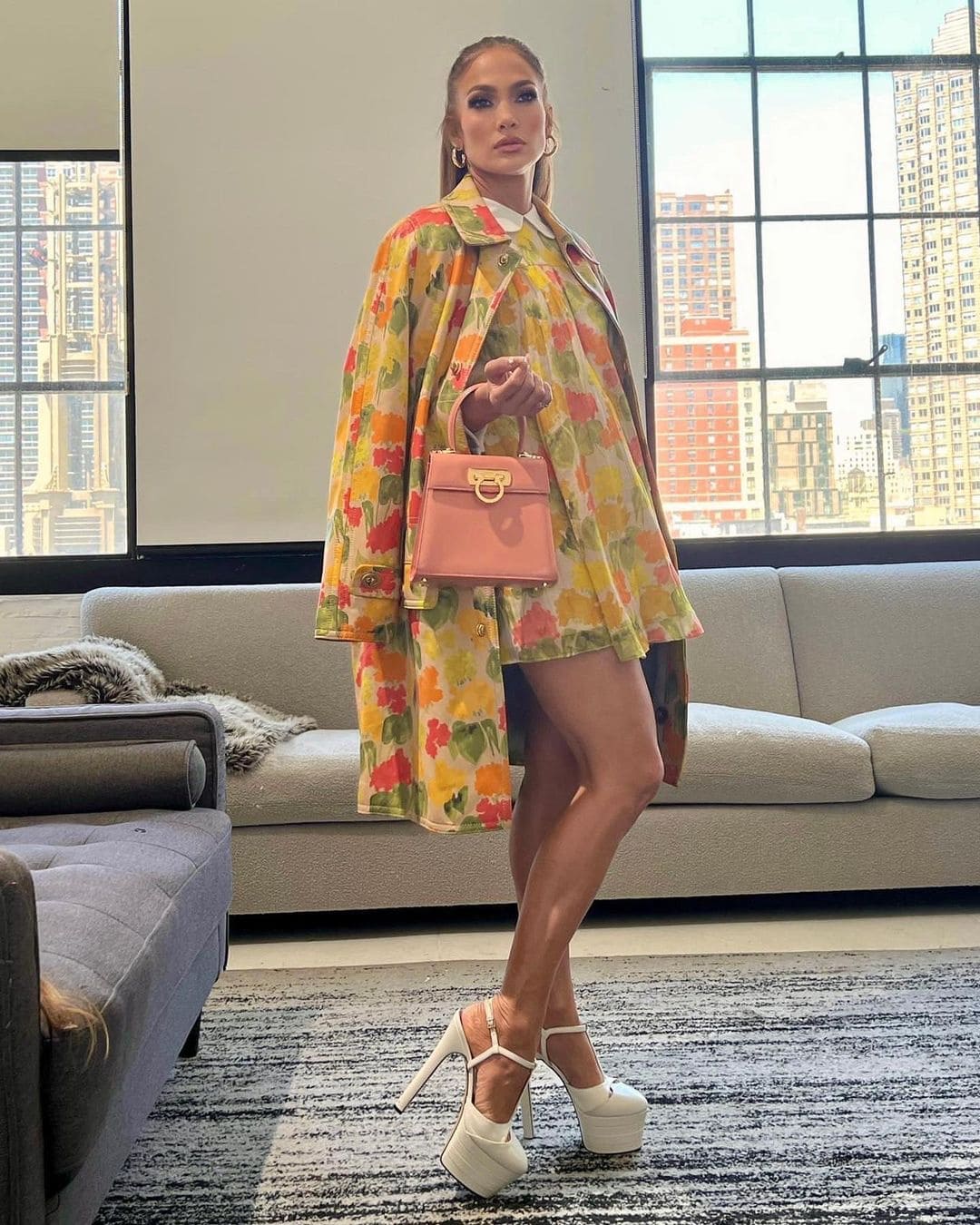 Jennifer Lopez wearing a Coach Fall 2022 outfit and Gucci white platform heels