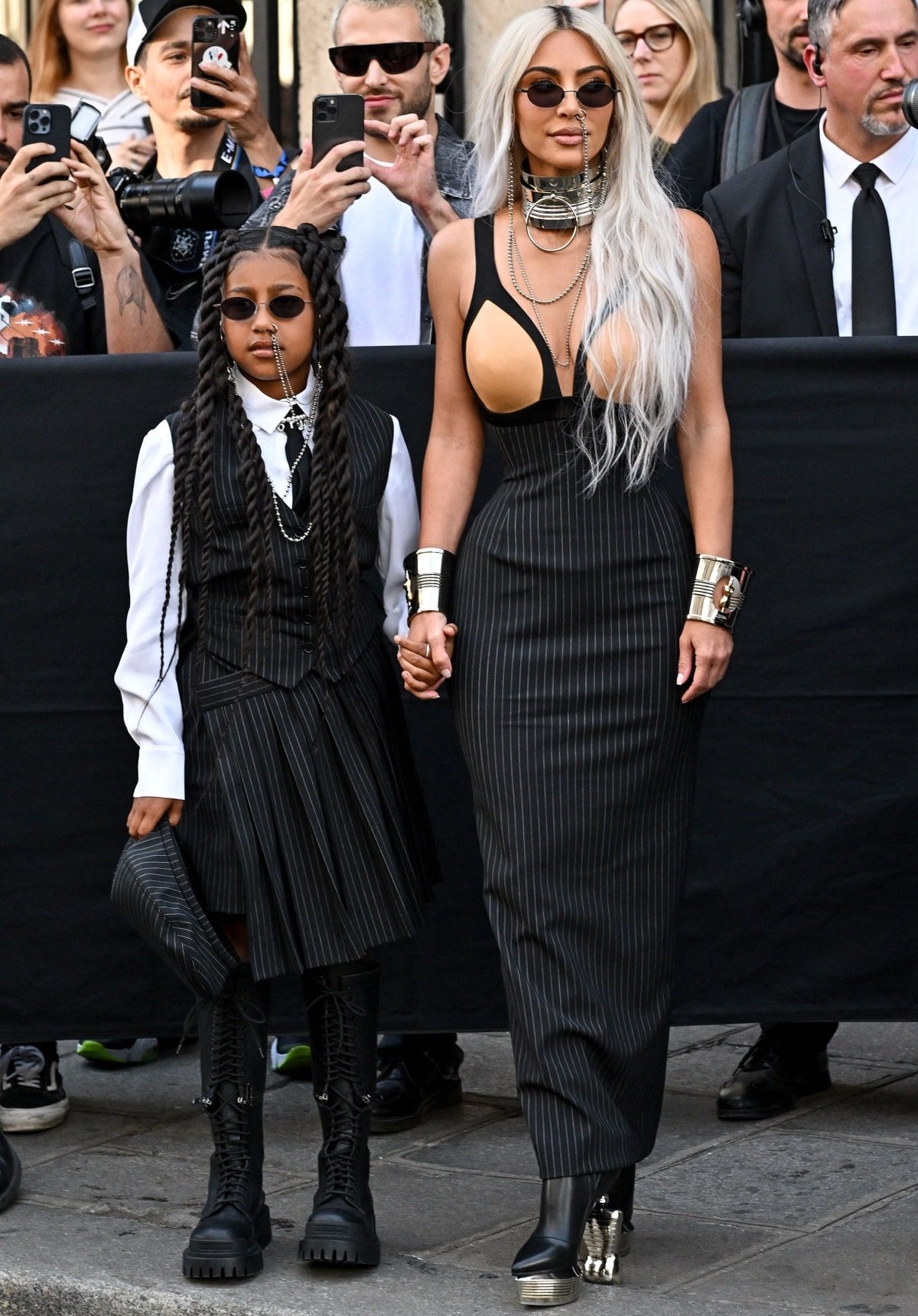 North West and Kim Kardashian in matching pinstriped looks with combat boots and platform heels