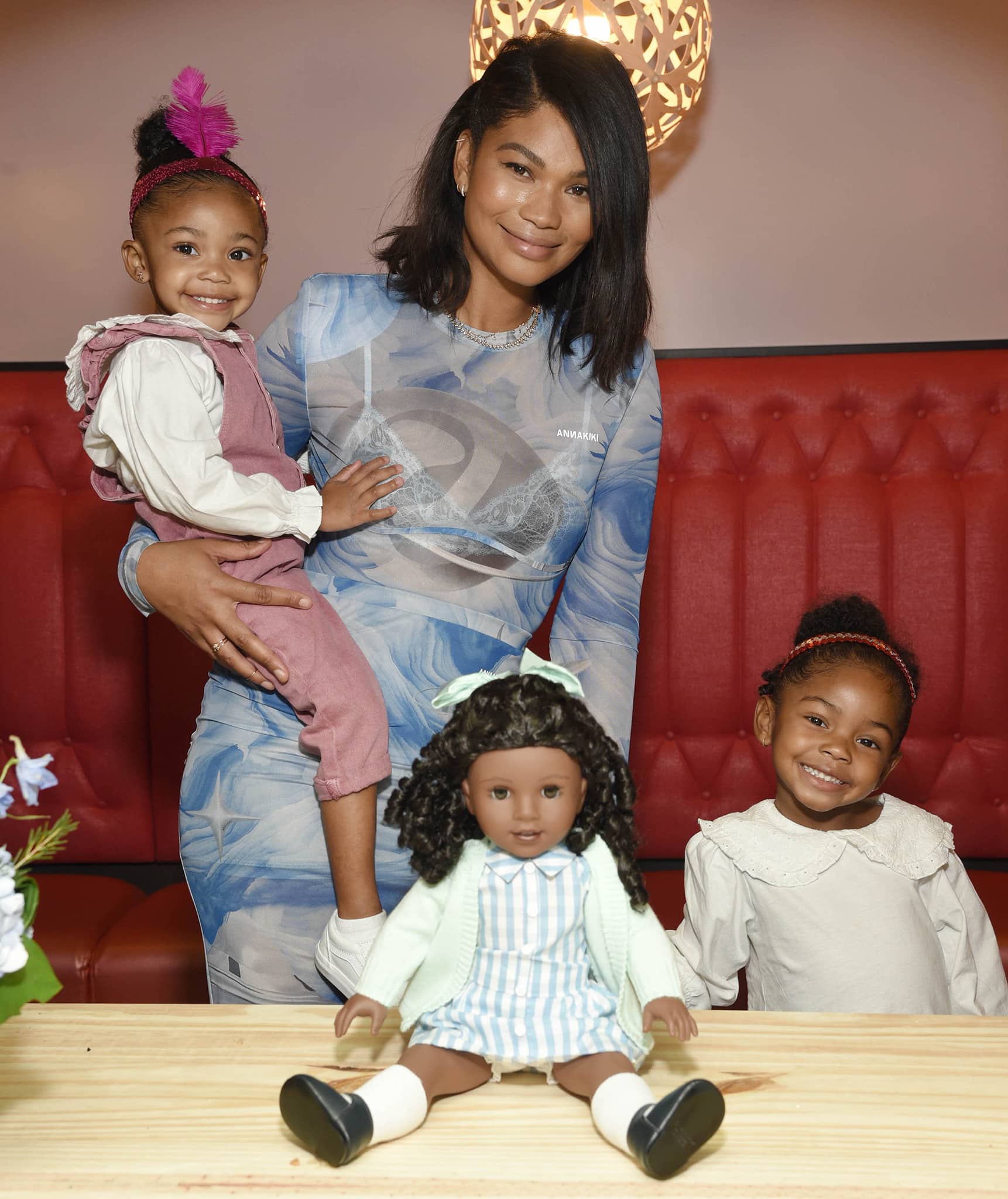 Cassie, 2, and Cali, 4, wear matching Peter Pan-collared long-sleeved white blouses