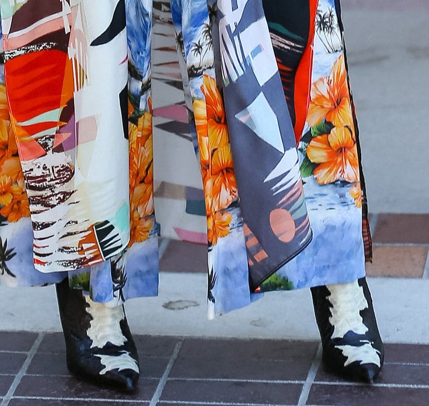 Heidi Klum teams her printed ensemble with black-and-white snakeskin stiletto boots