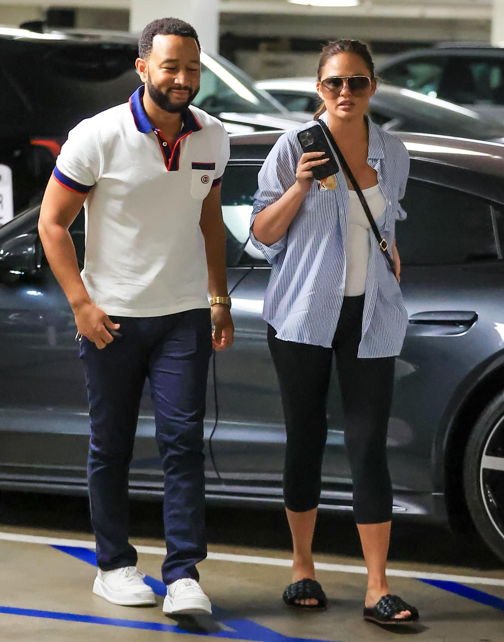 John Legend and Chrissy Teigen wearing casual outfits while heading to an appointment in Los Angeles on August 8, 2022