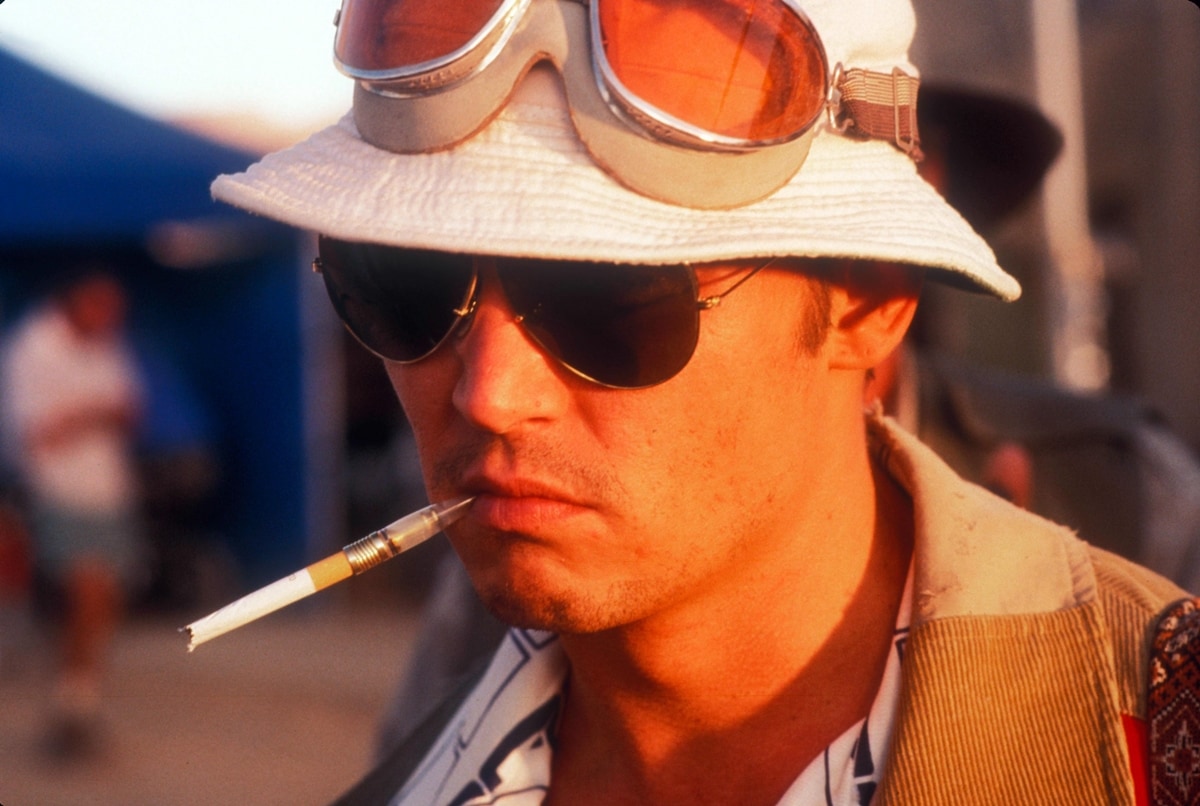Johnny Depp smoking a cigarette as Raoul Duke in the 1998 American black comedy adventure film Fear and Loathing