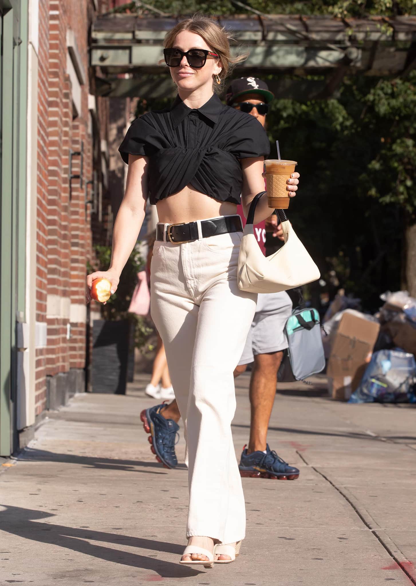 Julianne Hough flashes her toned abs in a Brandon Maxwell cropped black shirt and a pair of cream-colored Khaite straight-leg jeans