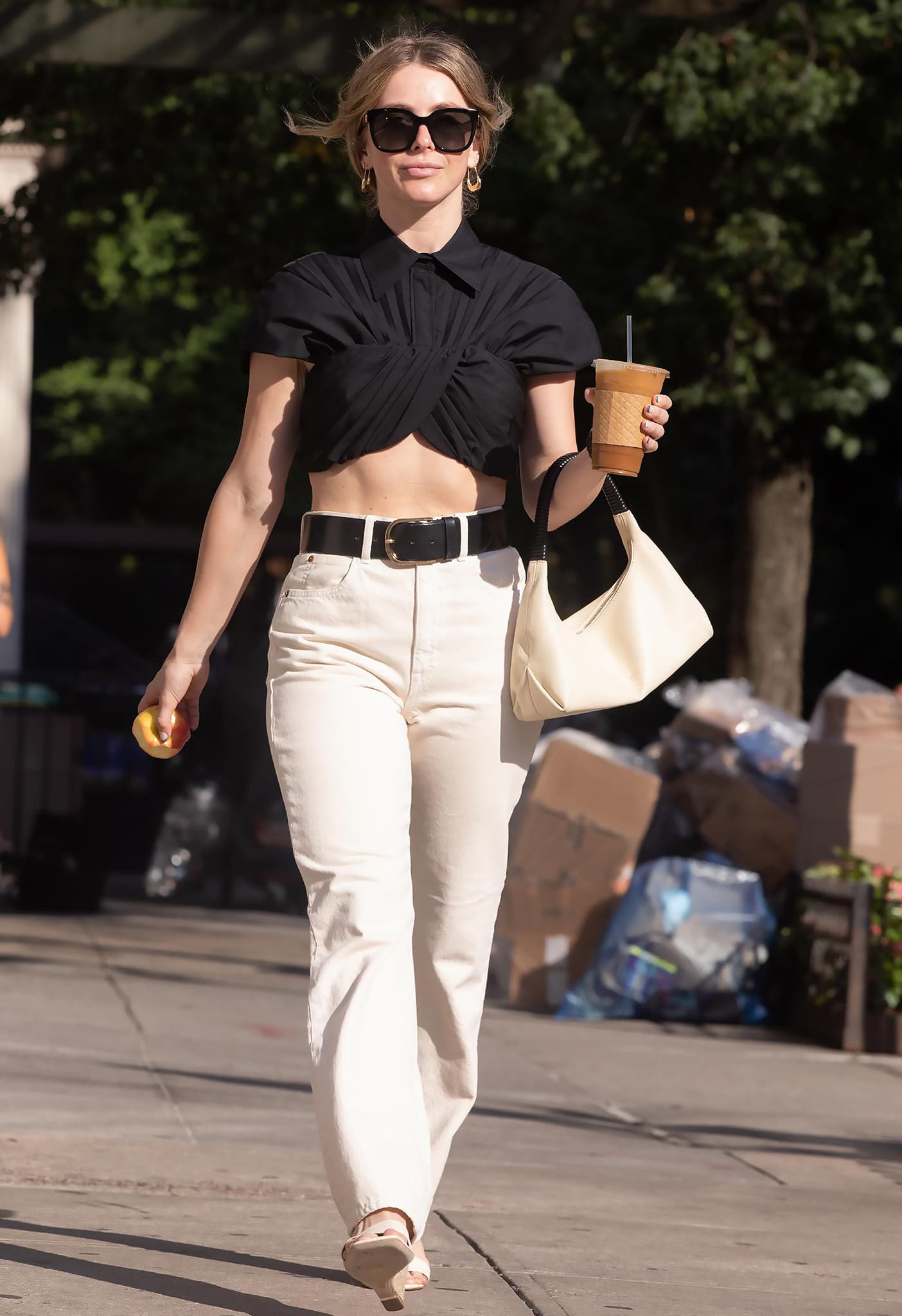 Julianne Hough carrying a cup of coffee on her way to her POTUS performance on August 2, 2022