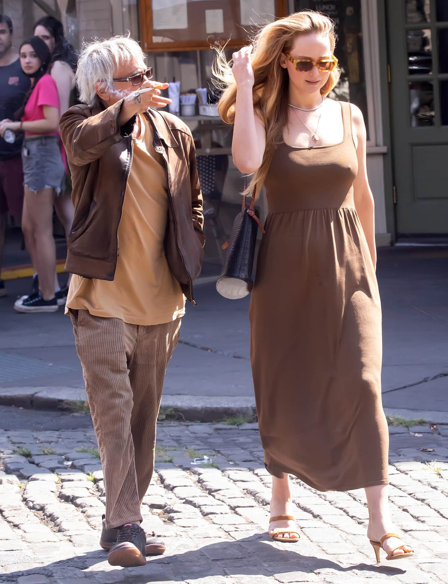 Leos Carax and Jennifer Lawrence coordinate in brown outfits for the lunch out