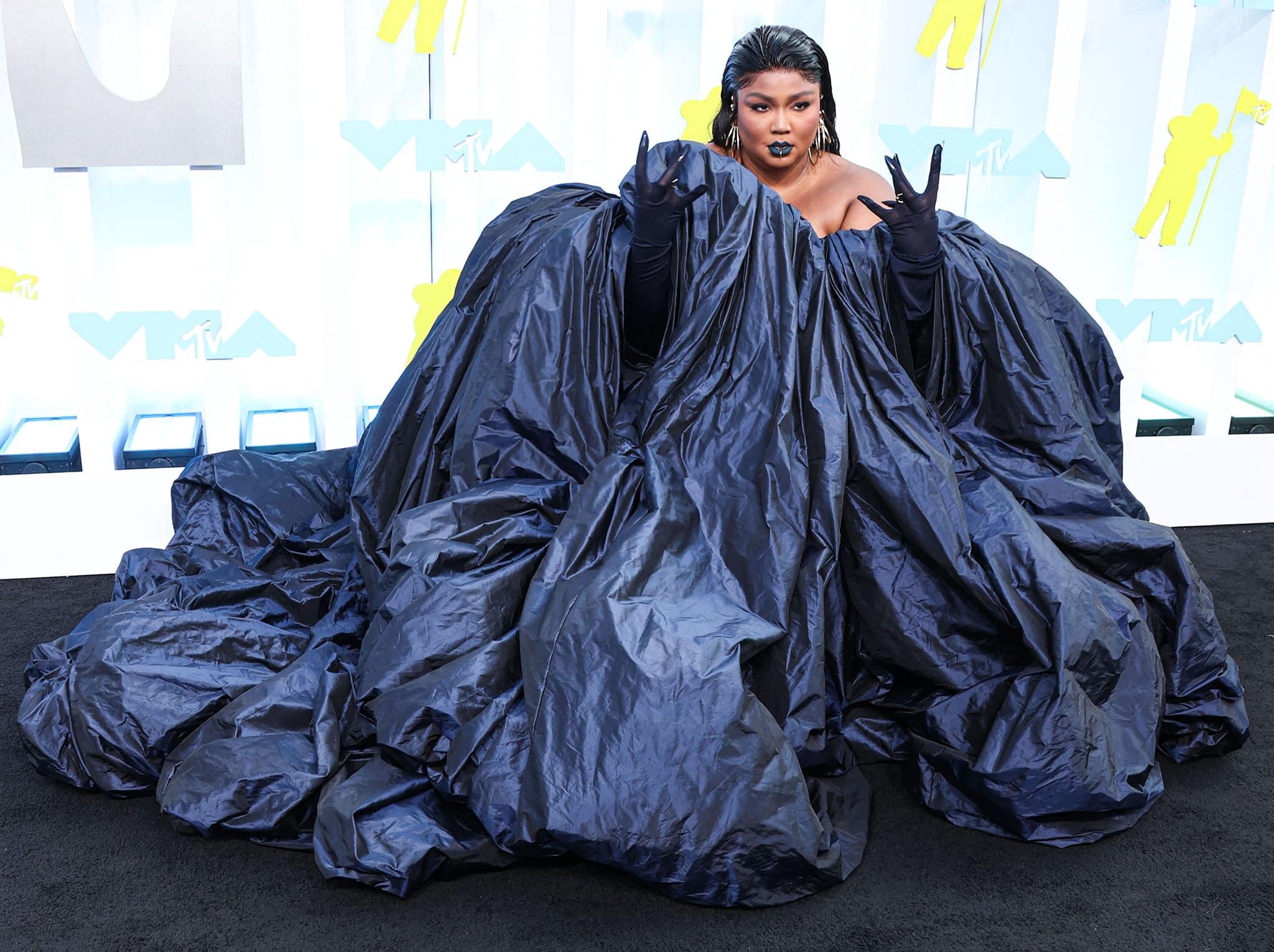 Lizzo pairs her supersized gown with black mesh opera gloves