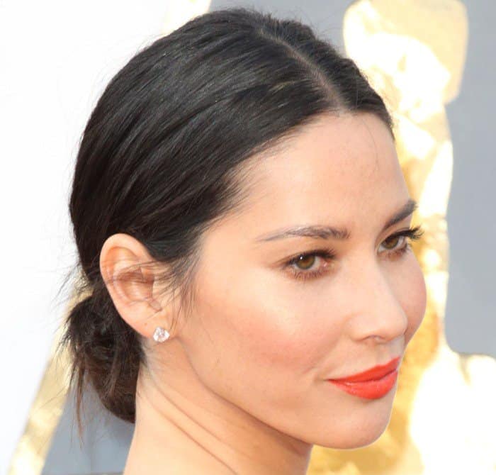 Olivia Munn shows off her stud Forevermark earrings featuring 4.84 carats of round brilliant diamonds set in 18-karat white gold