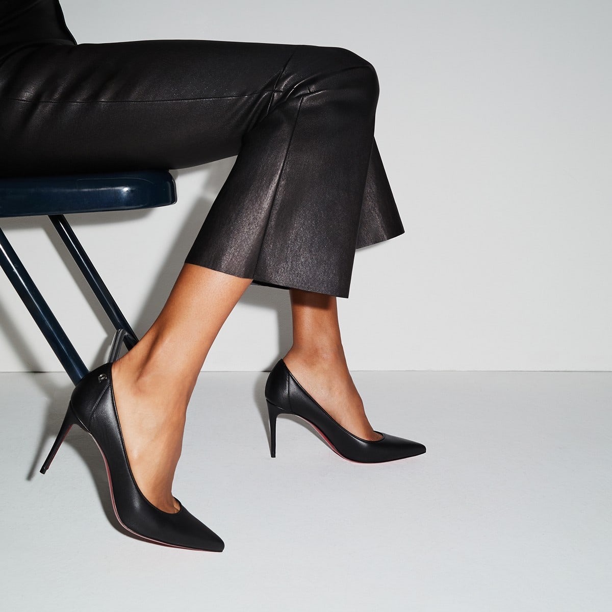 A sleek black nappa leather pump featuring a pointed toe, a plunging vamp to elegantly showcase the foot, set on an 85 mm heel, and adorned with the iconic Maison Christian Louboutin logo at the back