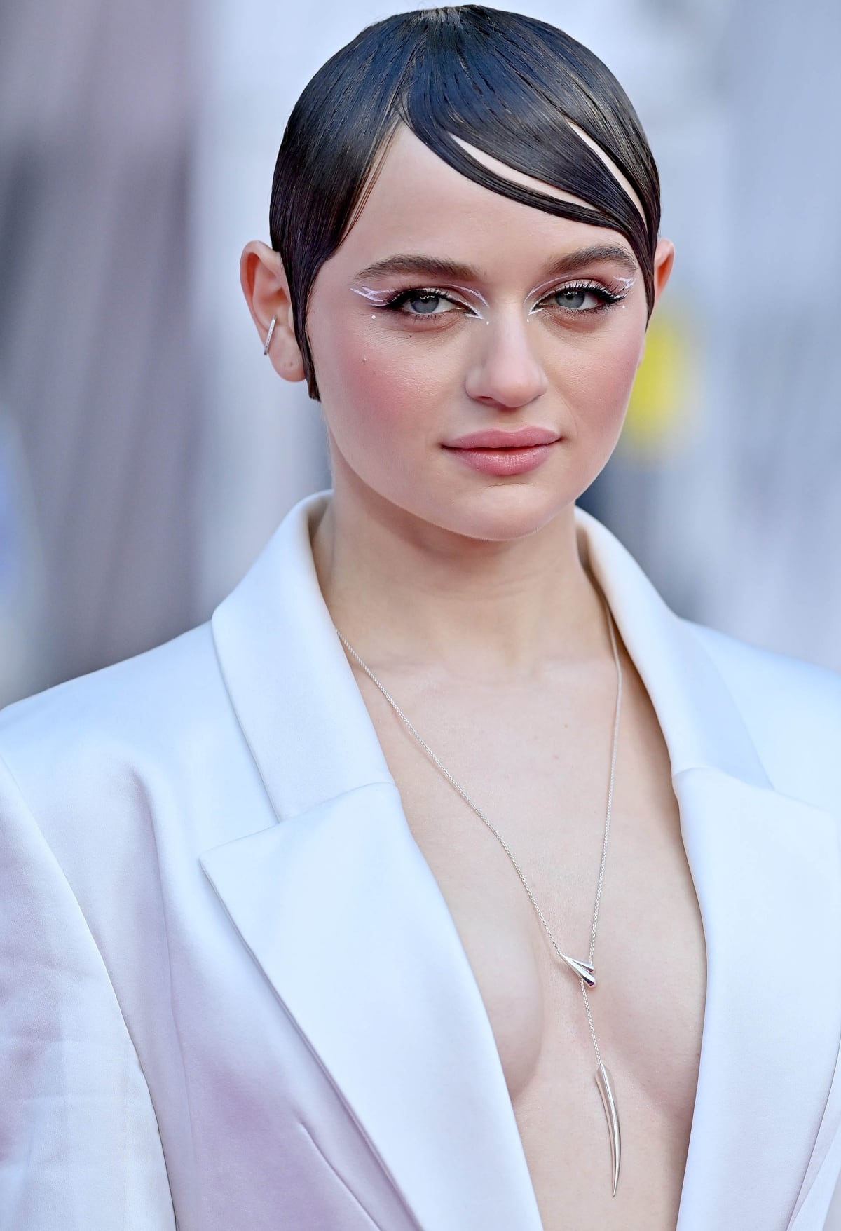 Joey King with a slicked-down hairstyle and graphic eyeliner