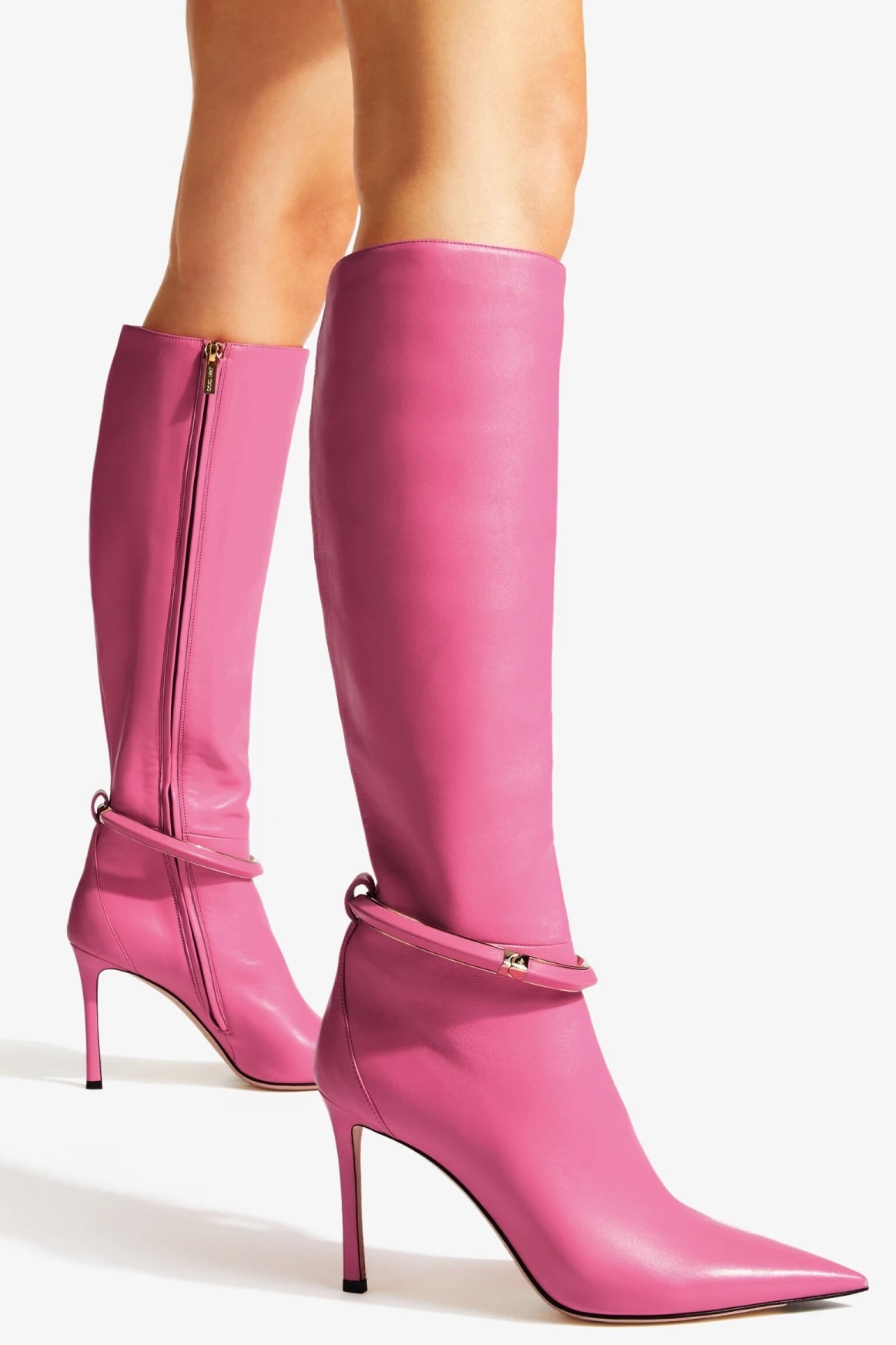 These candy pink boots are embellished with a gold-tone metal and leather cuff bracelet