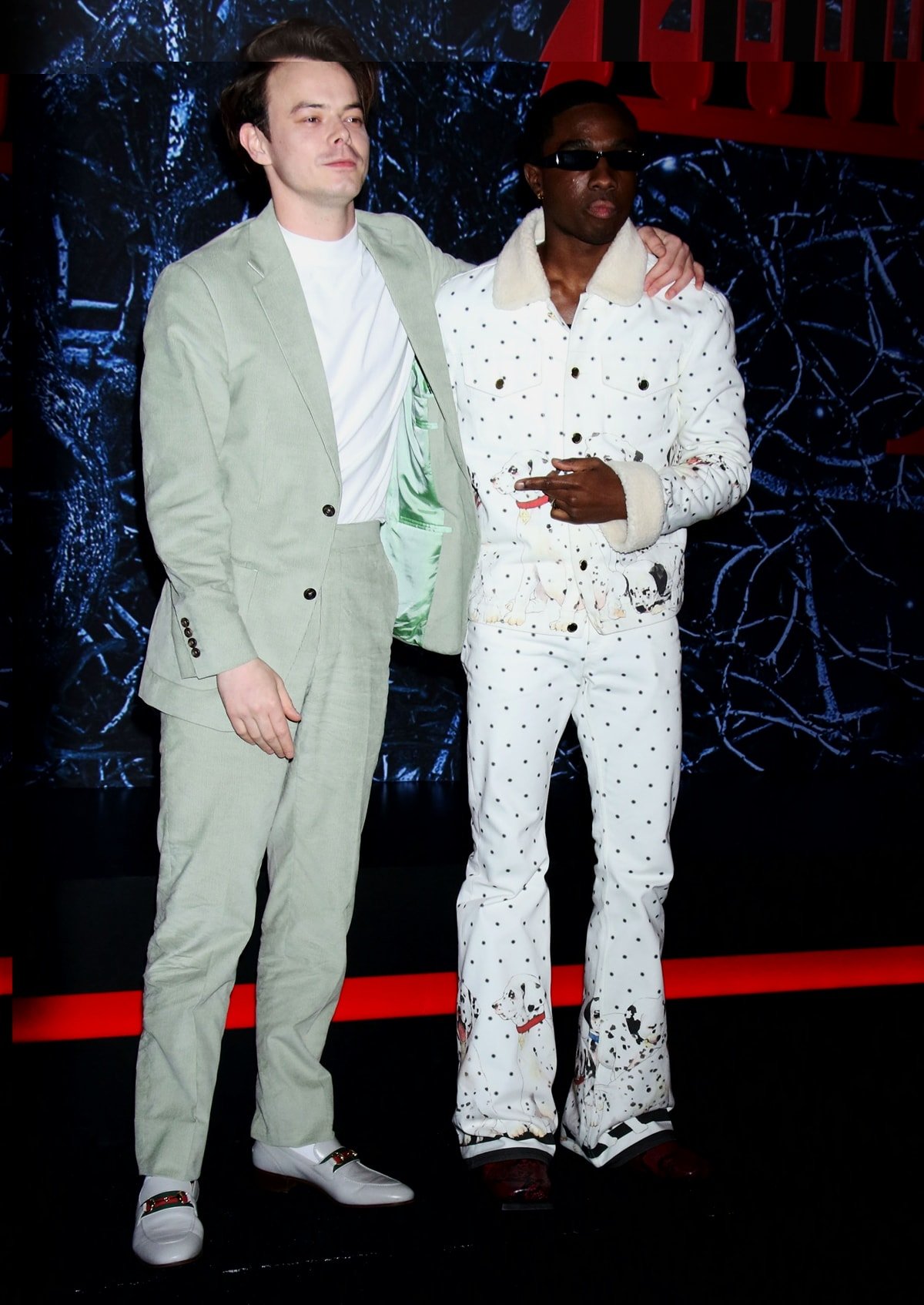 Charlie Heaton in a green suit with Gucci loafers and Caleb McLaughlin in a Dalmatian-themed Casablanca suit at Netflix's "Stranger Things" Season 4 New York Premiere