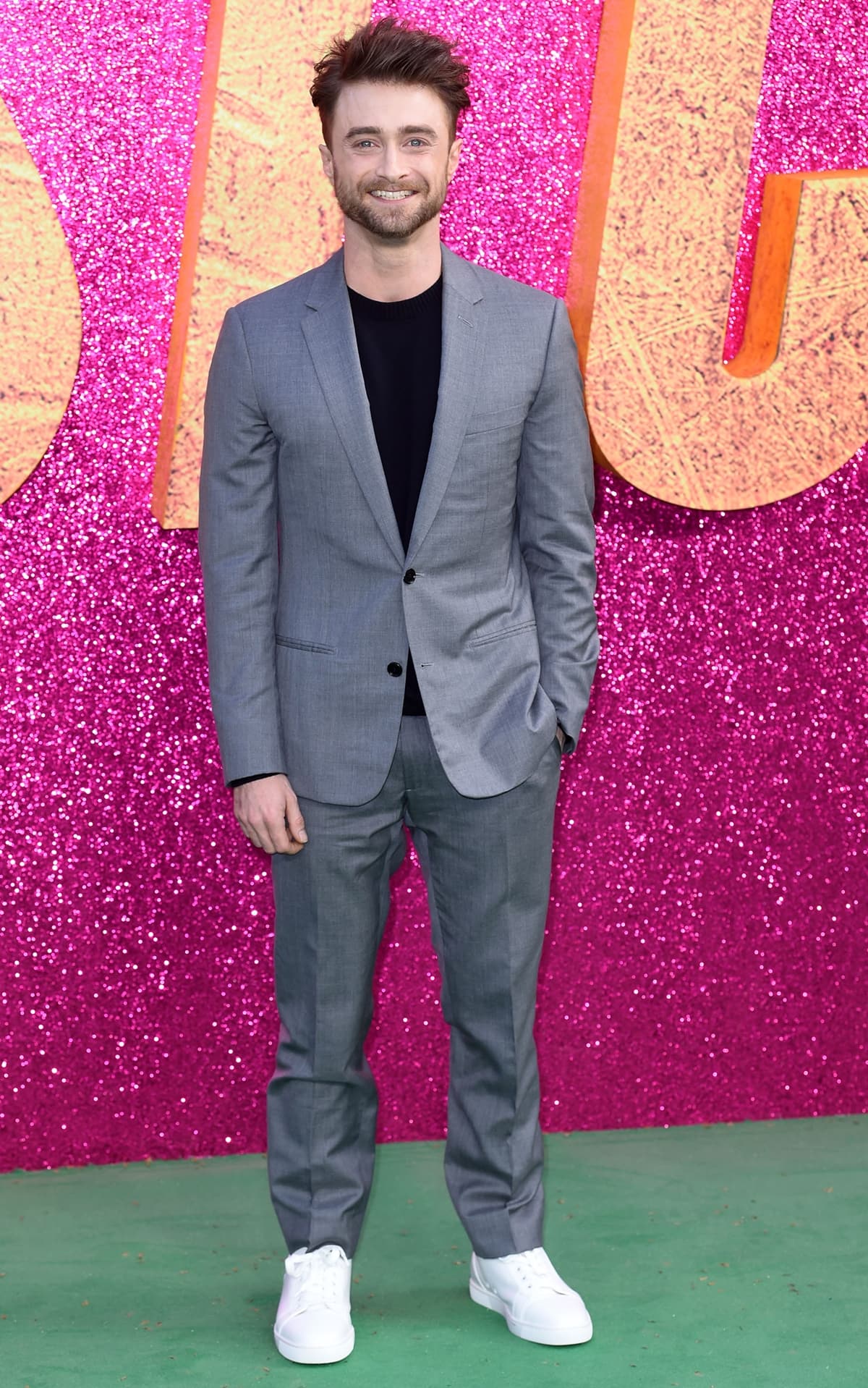 Daniel Radcliffe in a Dior Homme suit with white sneakers at the UK screening of "The Lost City"