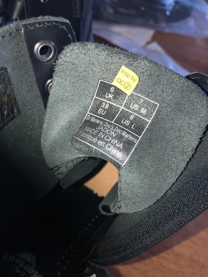 Dr. Martens shoes usually feature a small yellow inspection sticker underneath the tongue