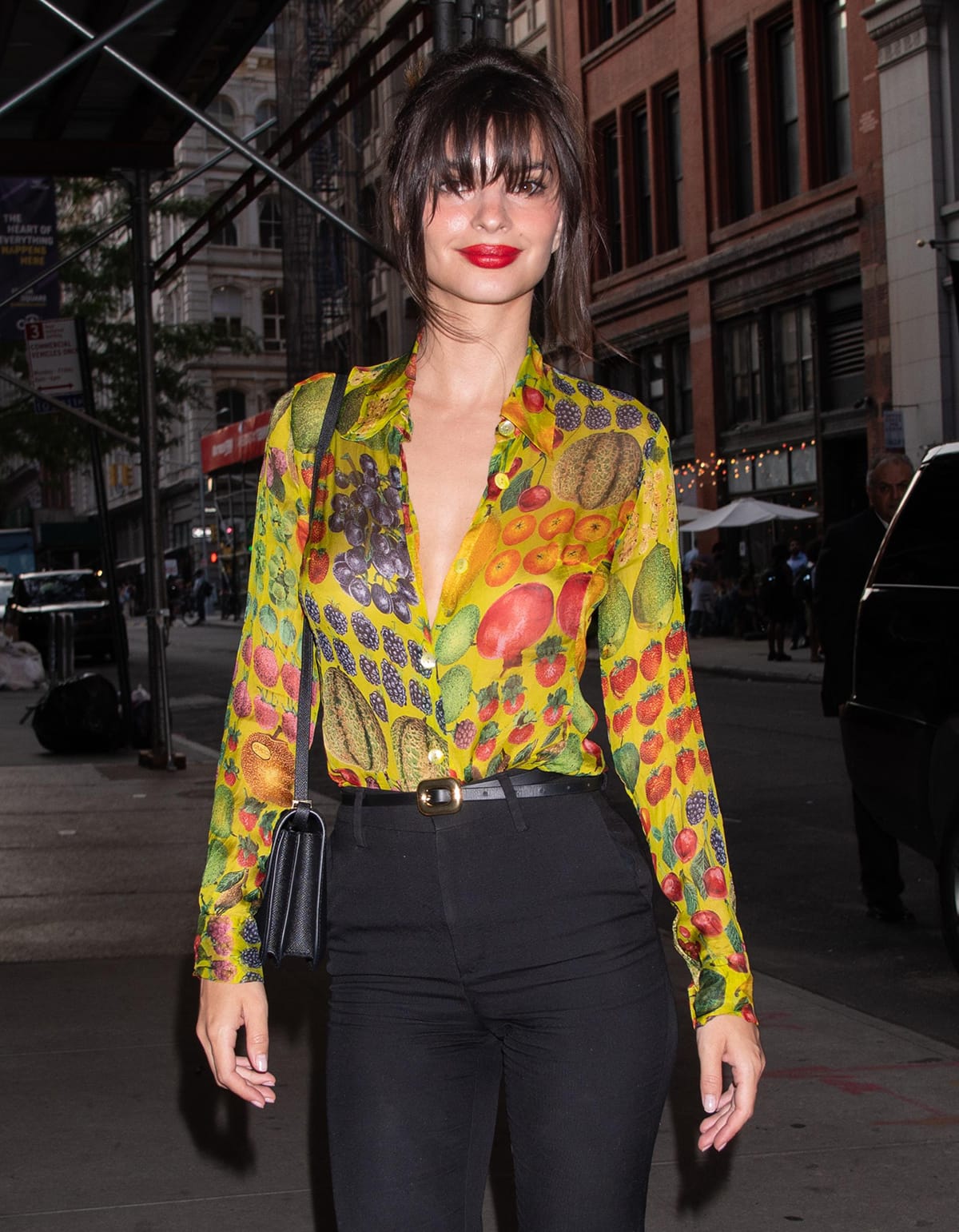 Emily Ratajkowski looks hot with red lipstick and a messy bun with wispy bangs