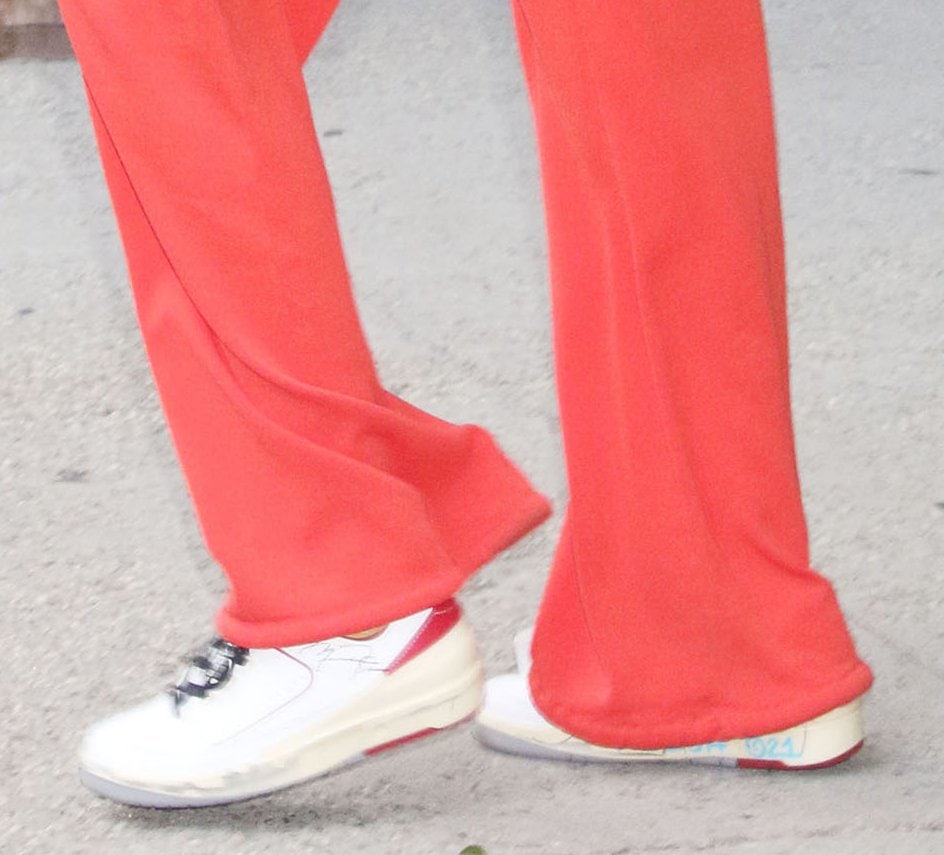 Gigi Hadid pairs her red outfit with Off-White x Nike Air Jordan 2 Low in White and Varsity Red