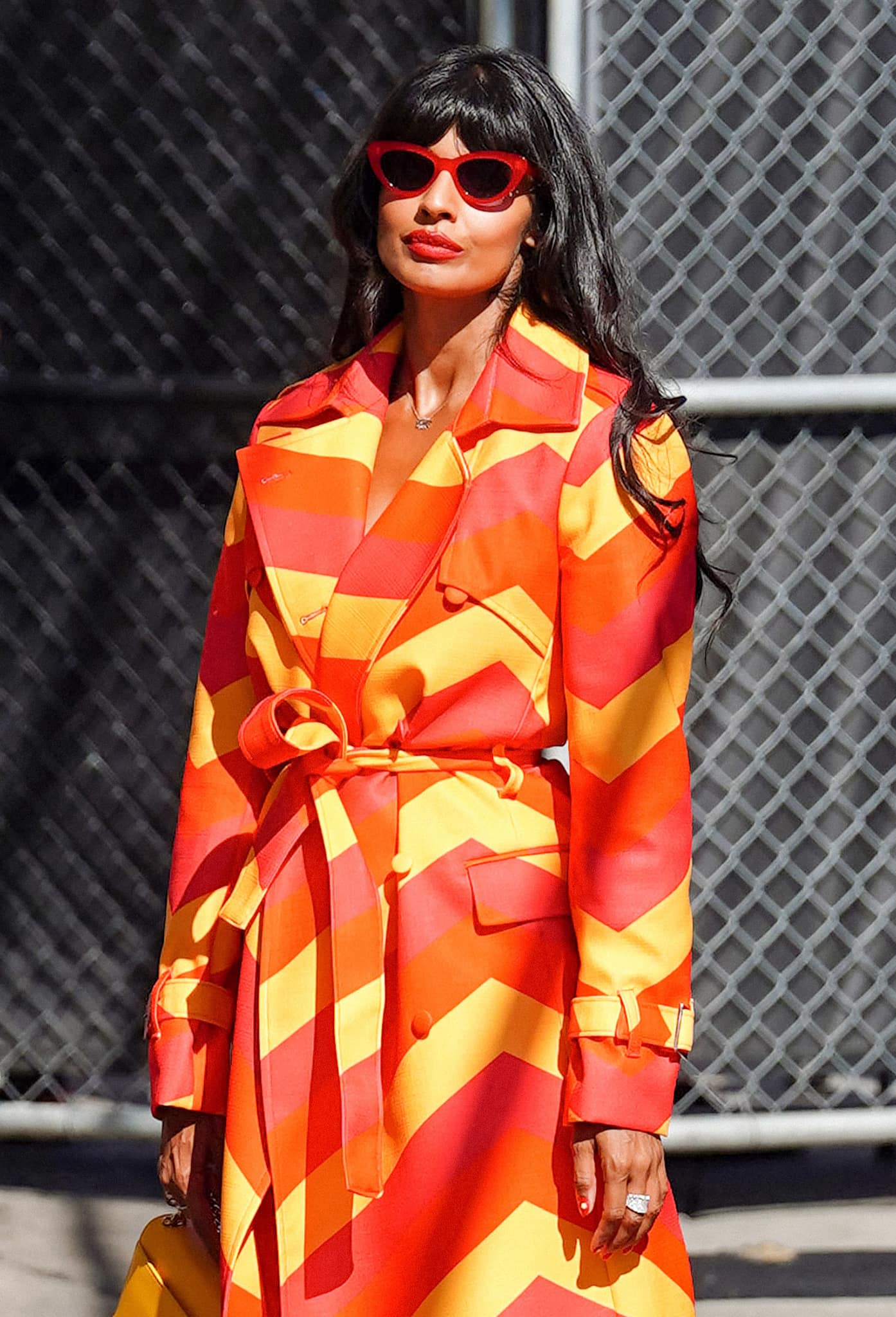 Jameela Jamil continues the vibrant theme of her look by wearing red Illesteva sunnies, red lipstick, and red nail polish