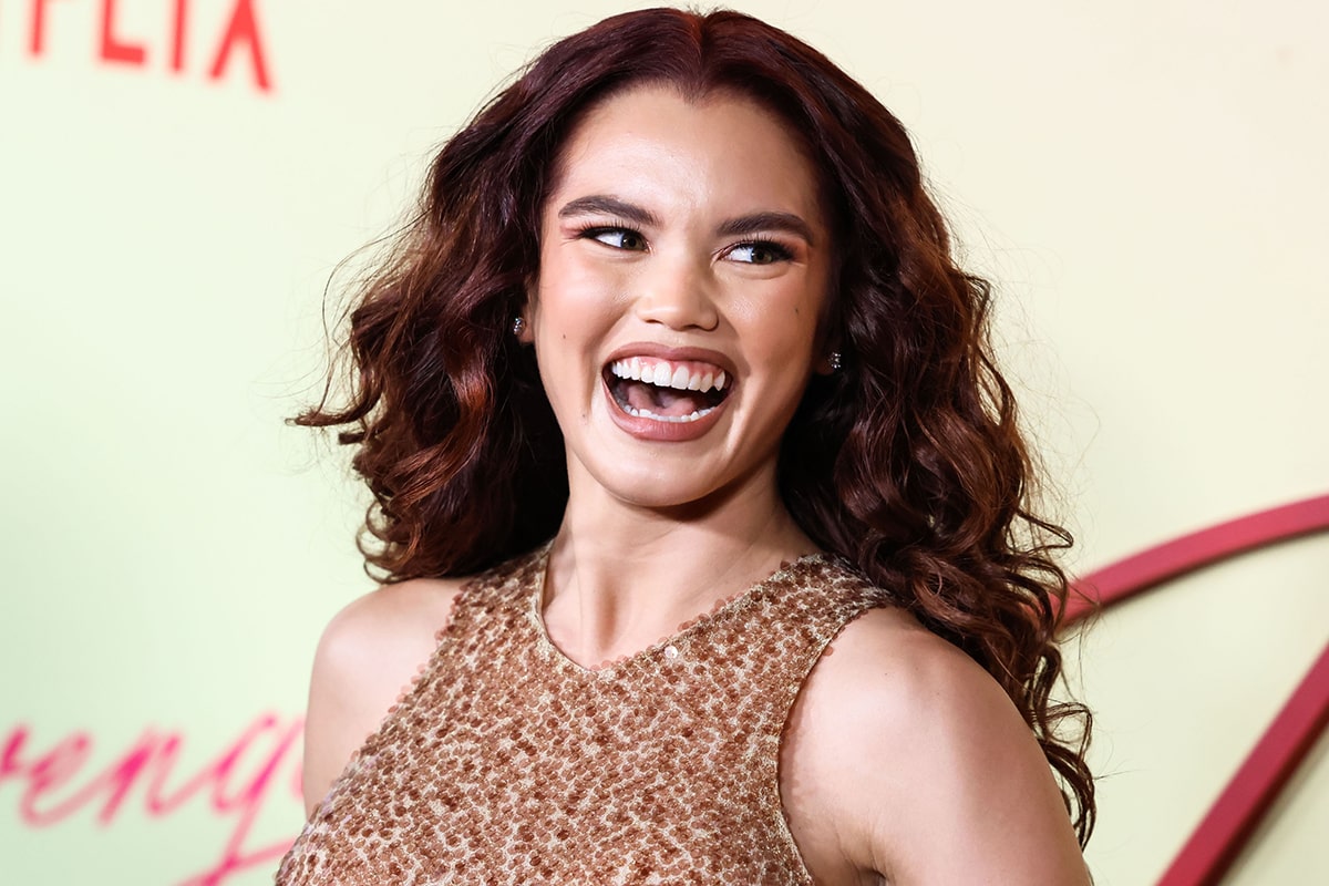 Paris Berelc styles her hair in voluminous curls and wears bronze smokey cat eyeshadow