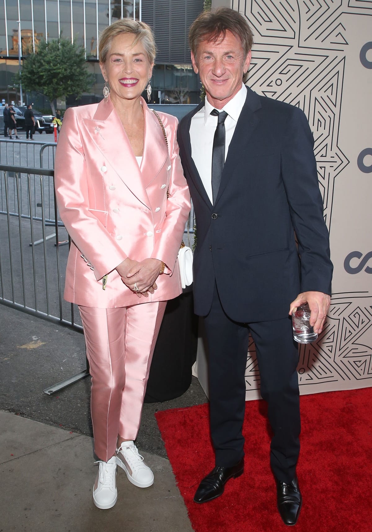 Sharon Stone, wearing a pink satin pantsuit and Dolce & Gabbana sneakers, joined Sean Penn at the 2022 CORE Gala