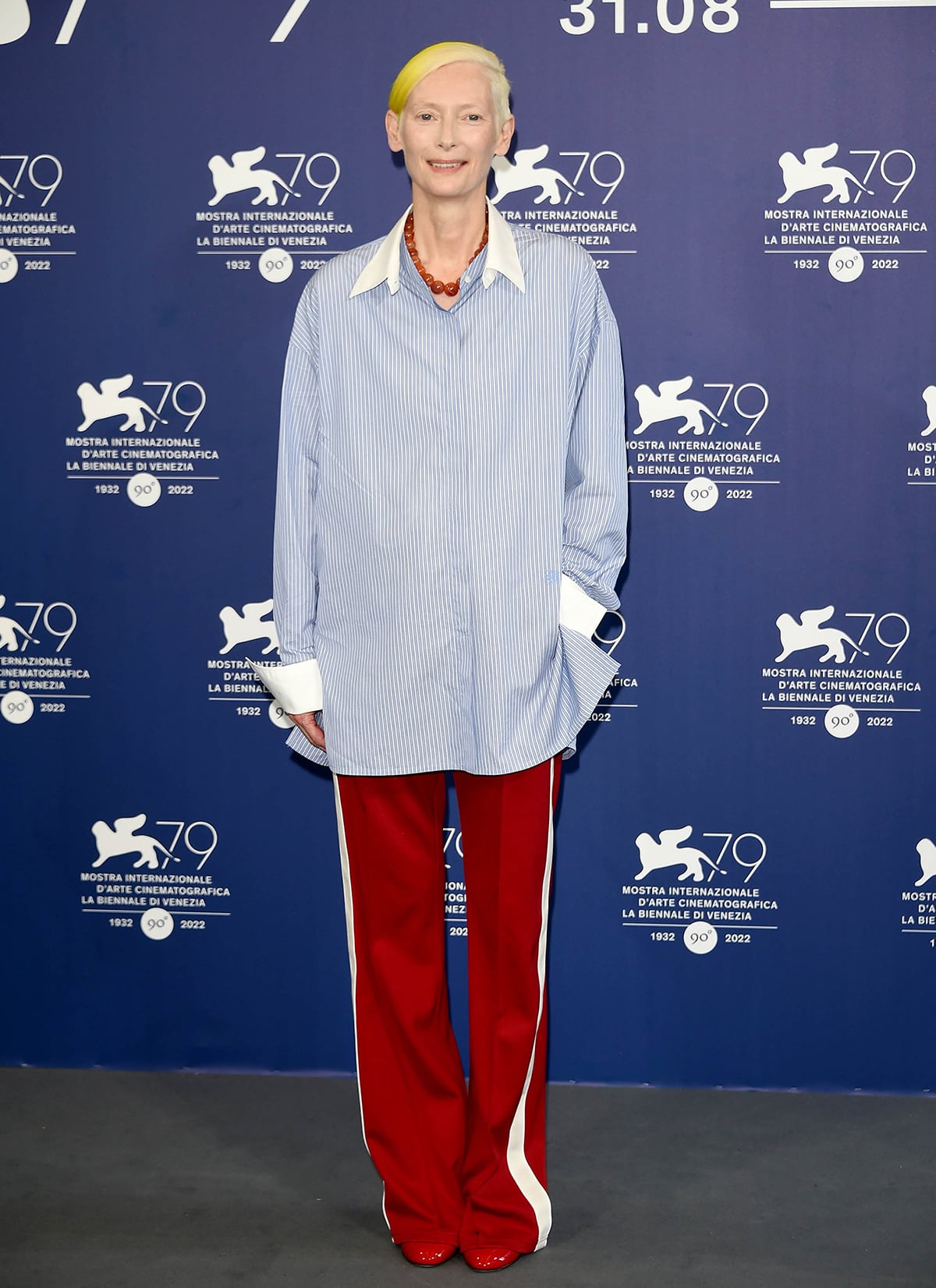 Tilda Swinton honors Ukraine by dyeing her signature short hair yellow and wearing a blue pinstripe shirt by Loewe