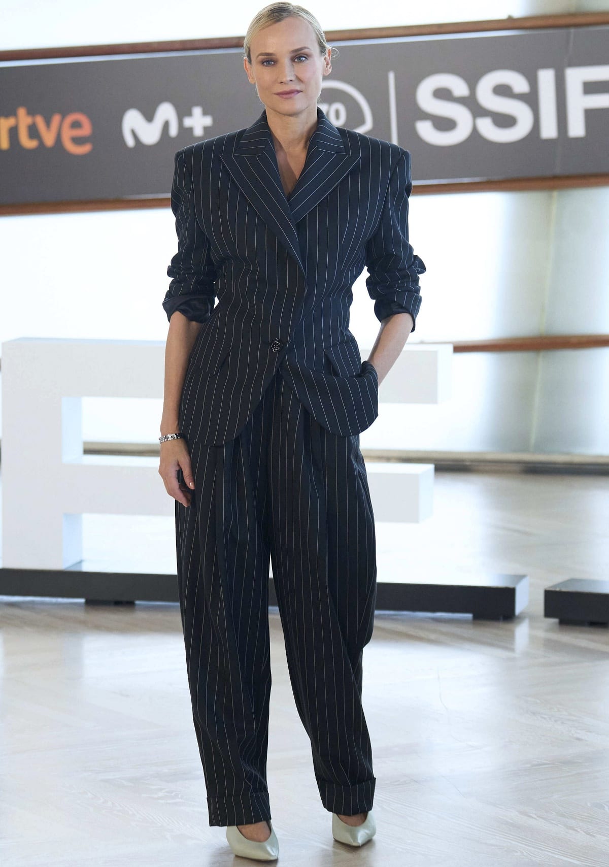 Diane Kruger wearing an Alexandre Vauthier oversized pinstripe suit with white pointy-toe pumps