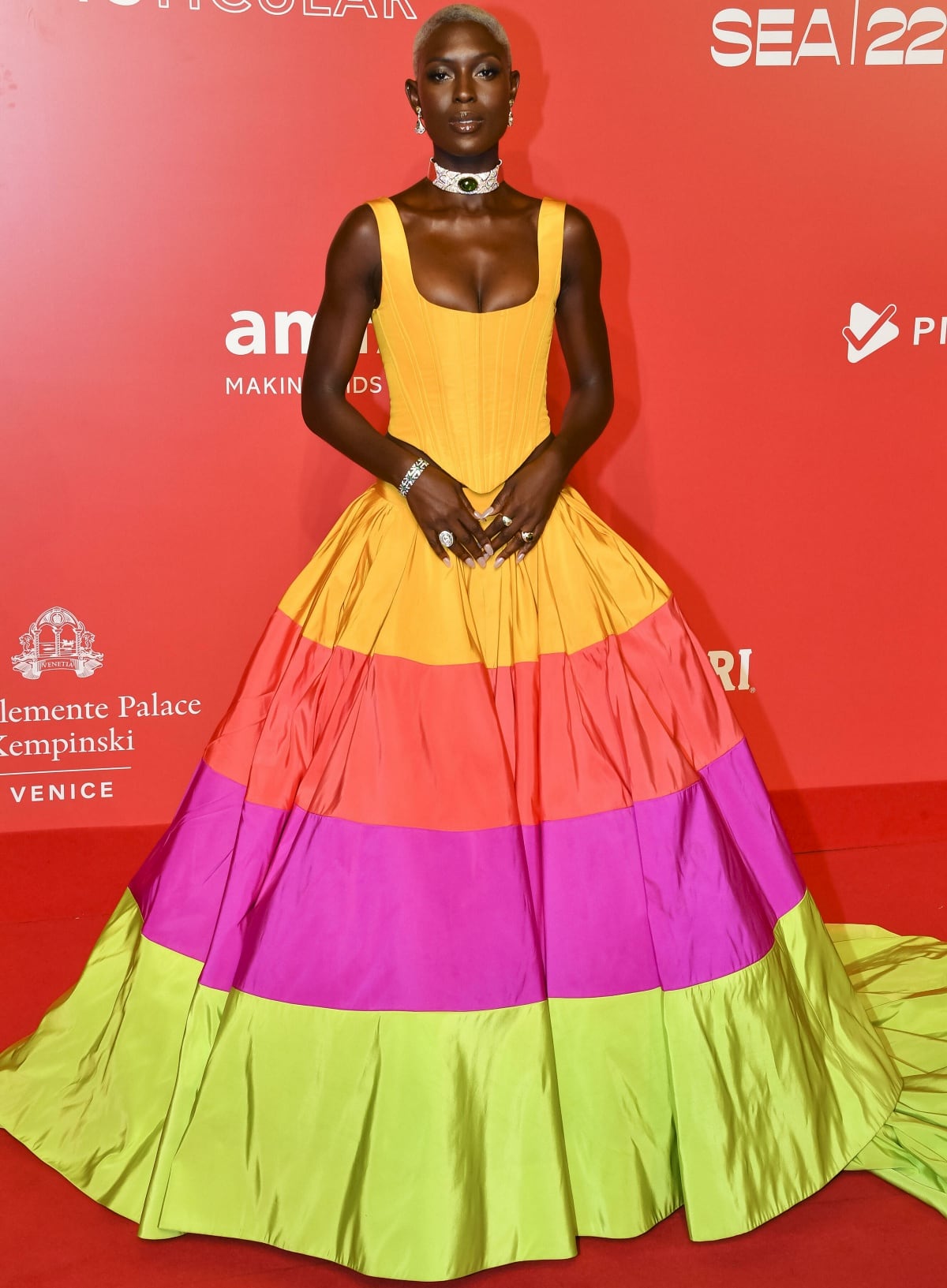 Jodie Turner-Smith stepping out with a blonde buzzcut and a multicolored sleeveless gown from Christopher John Rogers
