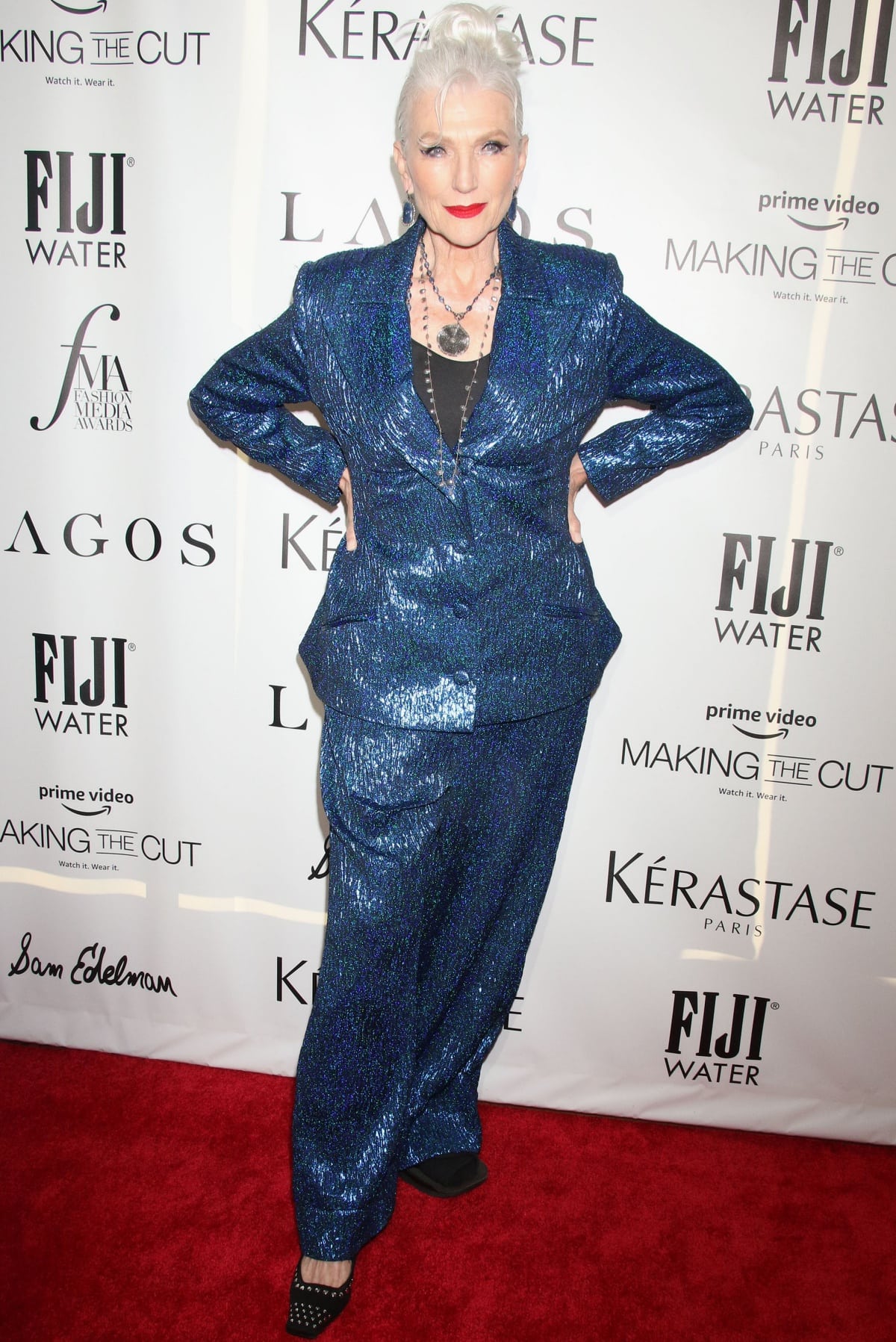 Maye Musk wearing a blue embellished suit with embellished heels