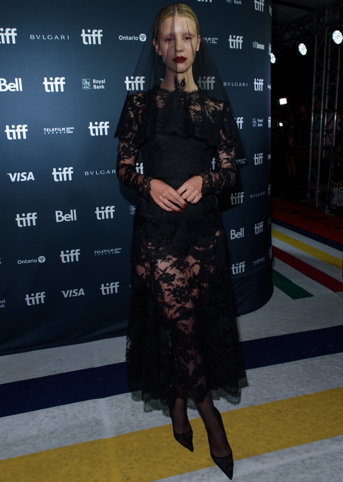 Mia Goth wearing a Dolce & Gabbana Alta Moda black lace dress with a lace veil at the 47th Toronto International Film Festival premiere of Pearl