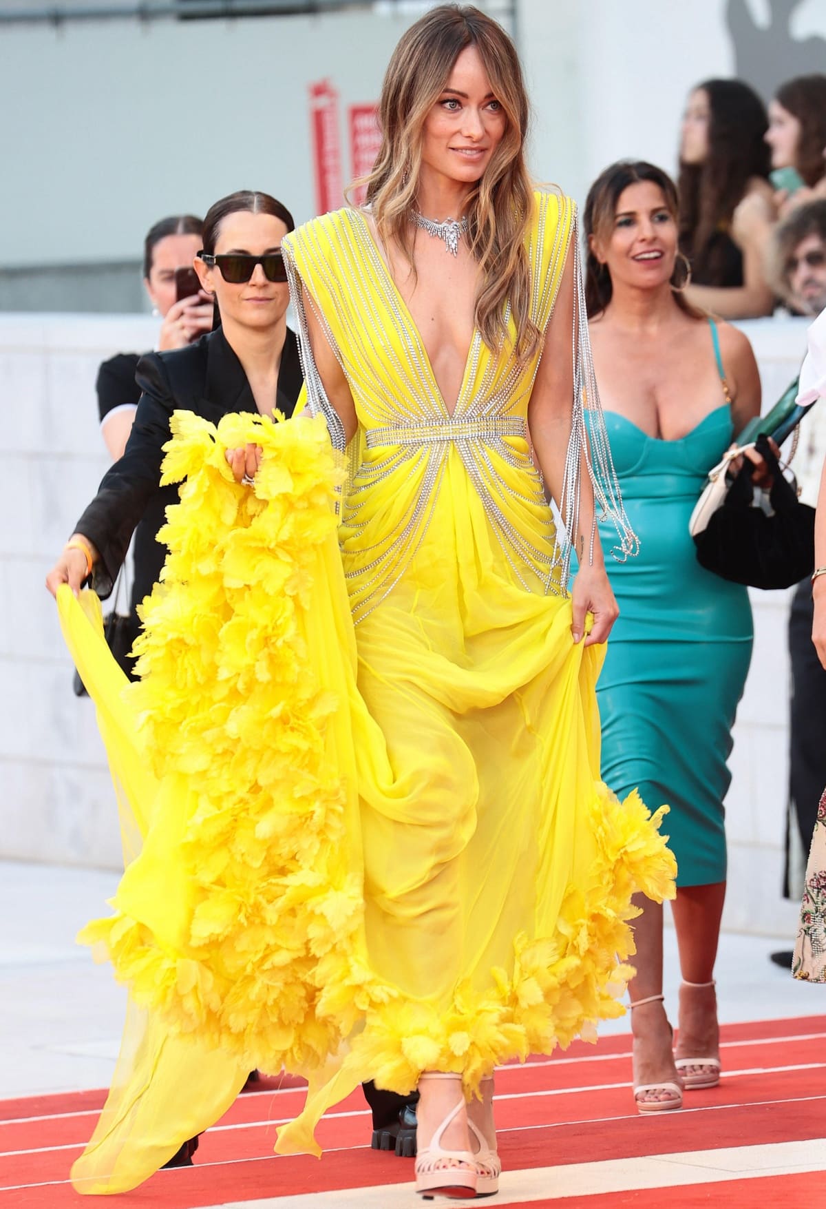 Olivia Wilde wearing strappy heels with her custom yellow Gucci gown